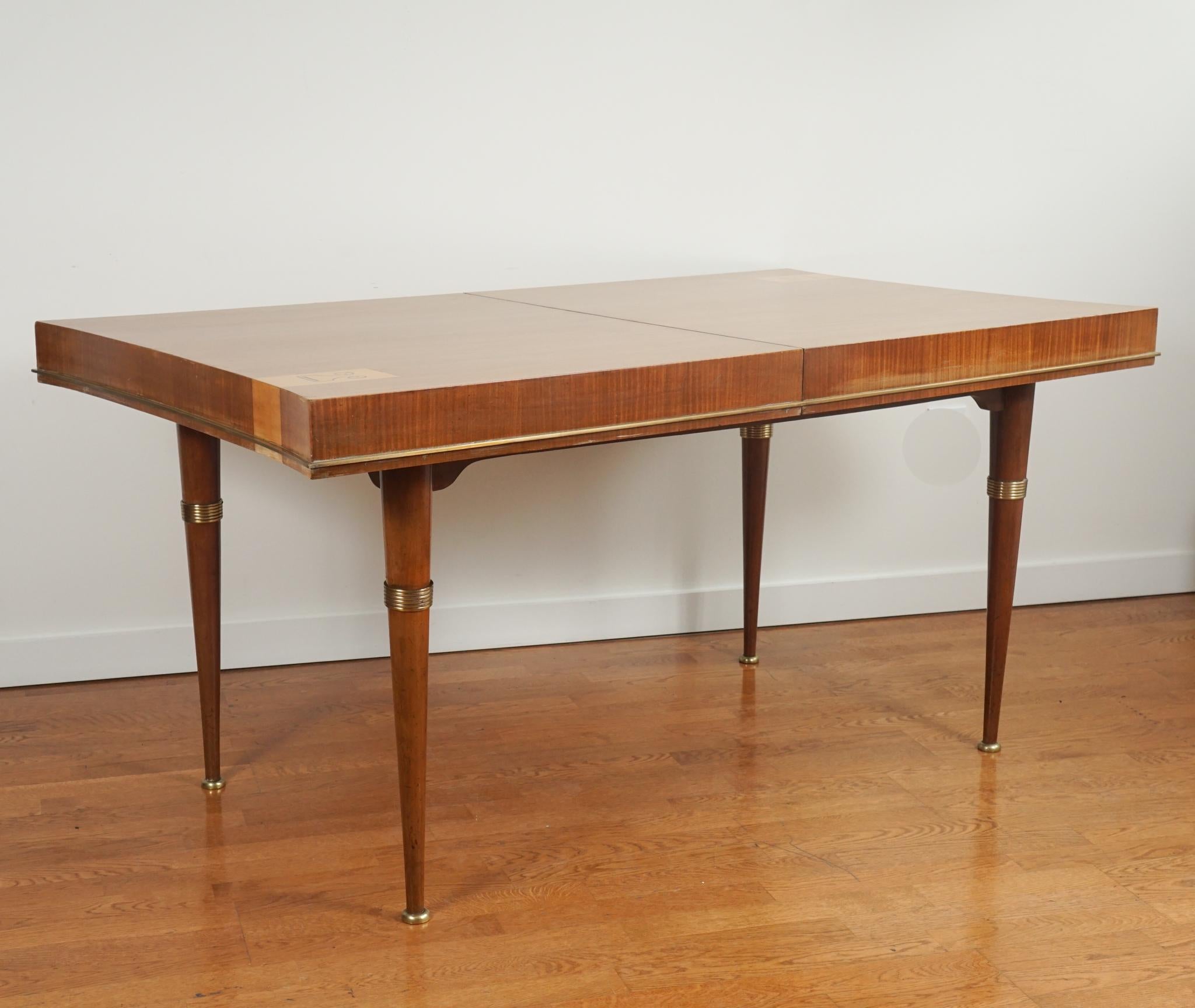 The furniture of French designer André Arbus is remembered for reintroducing neo-classicism to early and middle twentieth century design.  The extendable mahogany dining table from 1945, shown here, is in the manner of Arbus.  The graceful legs,