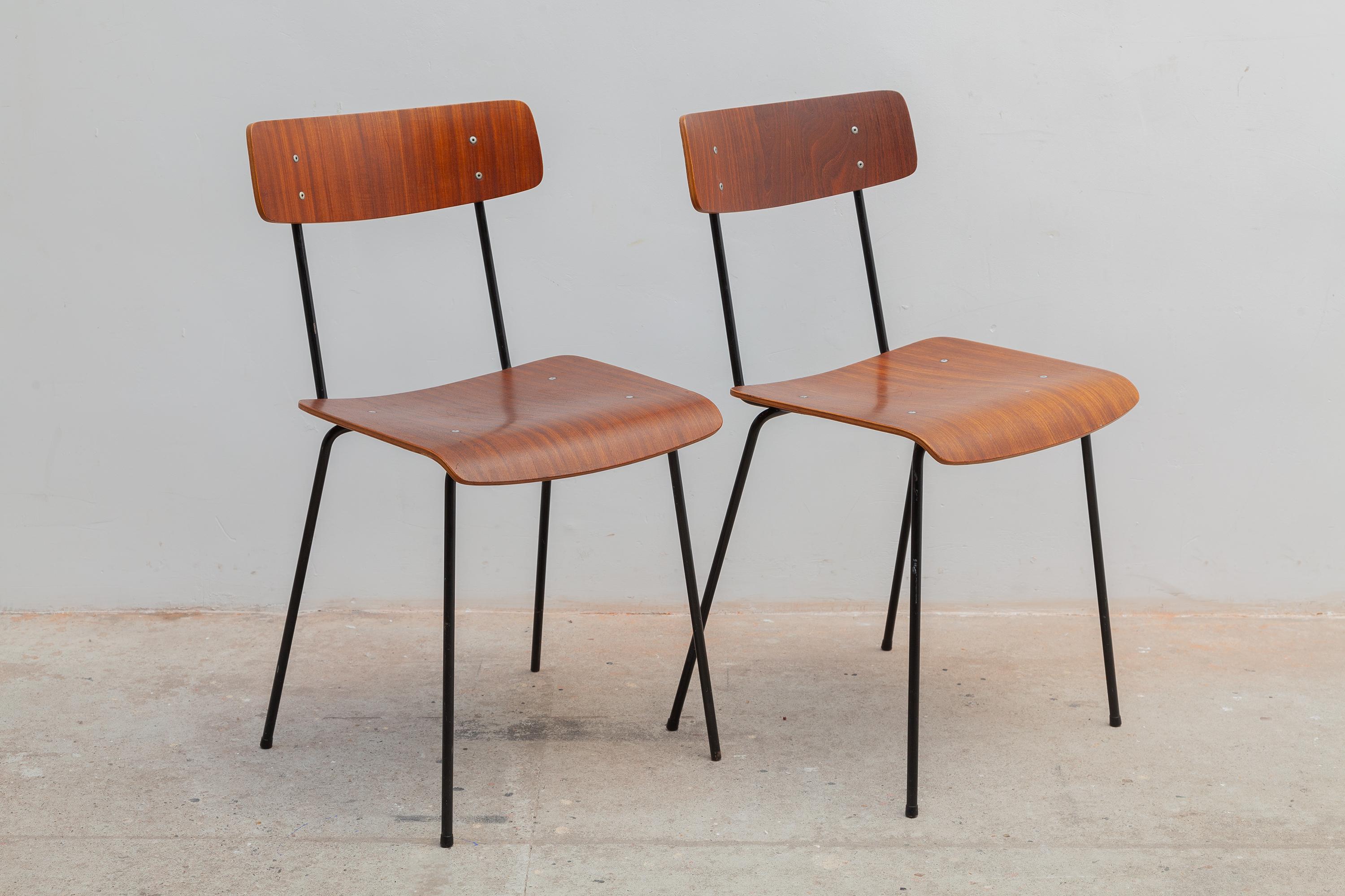 Classic Mid-Century Modern design set of 2 Minimalist plywood dining chairs designed by André Cordemeyer in 1959 for Dutch Industrial Manufacture Gispen. Black lacquered metal frame and teak veneered plywood seat and backrest.
Dimensions: 40 W x 78