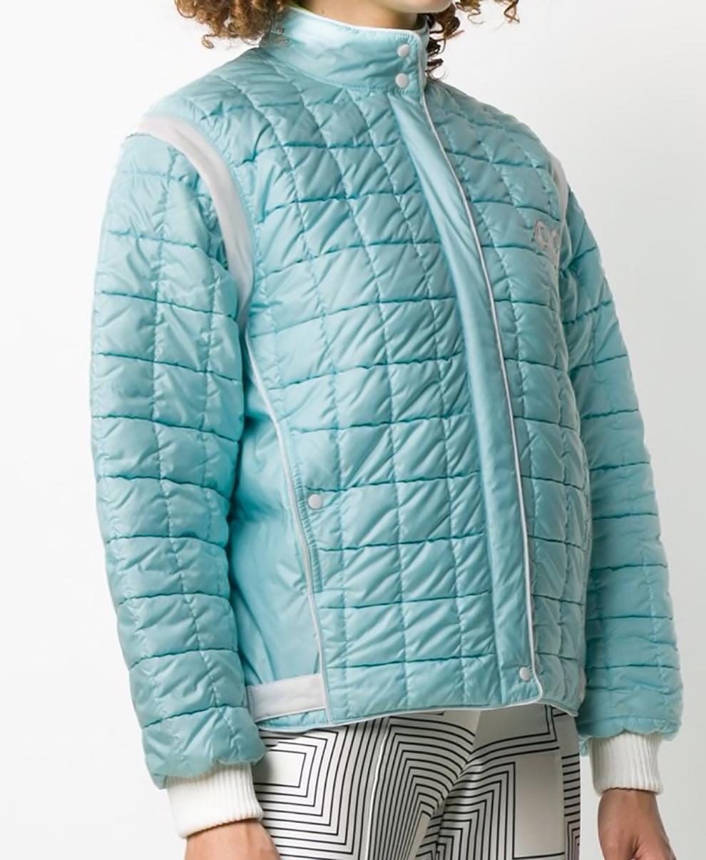Andre Courreges turquoise blue and white 1980s Sport Futur jacket featuring a quilted effect, a padded interior, ribbed details, dropped shoulders, a stand up collar, a zip and press stud fastening, long sleeves, side pockets and a full lining.