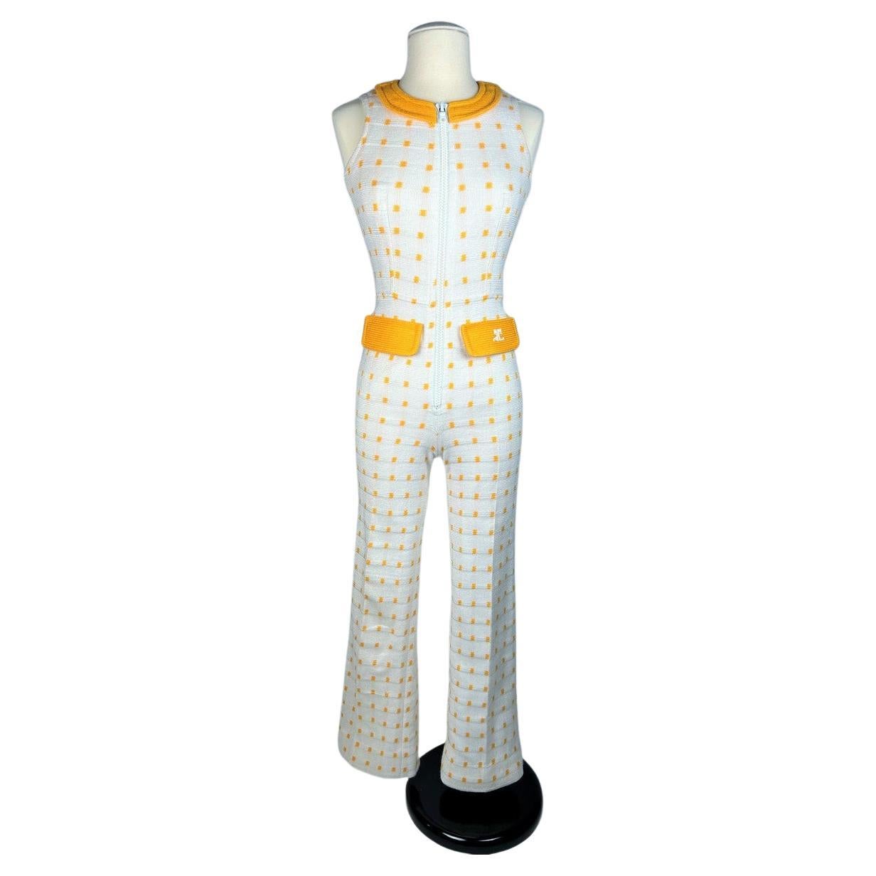 Circa 1970

France

An André Courrèges Hyperbole 00 Jumpsuit numbered 050237 dating from the early 1970s. Made from white wool knit with small orange-yellow checks, this jumpsuit is sleeveless, with a round collar fastened by a white plastic zip at