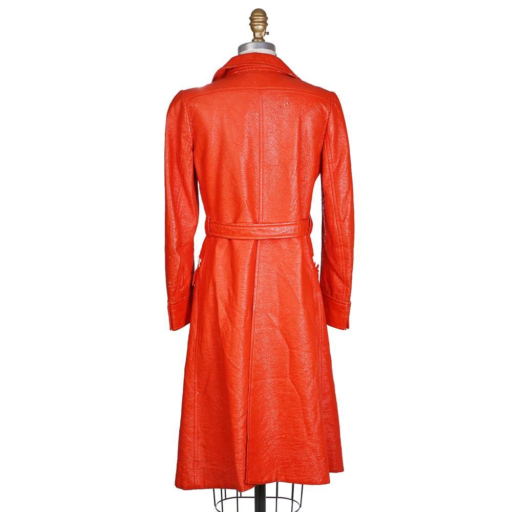 Trench by Andre Courreges circa 1960s/1970s
Orange leather with white details
Includes snap button belt 
Retro 