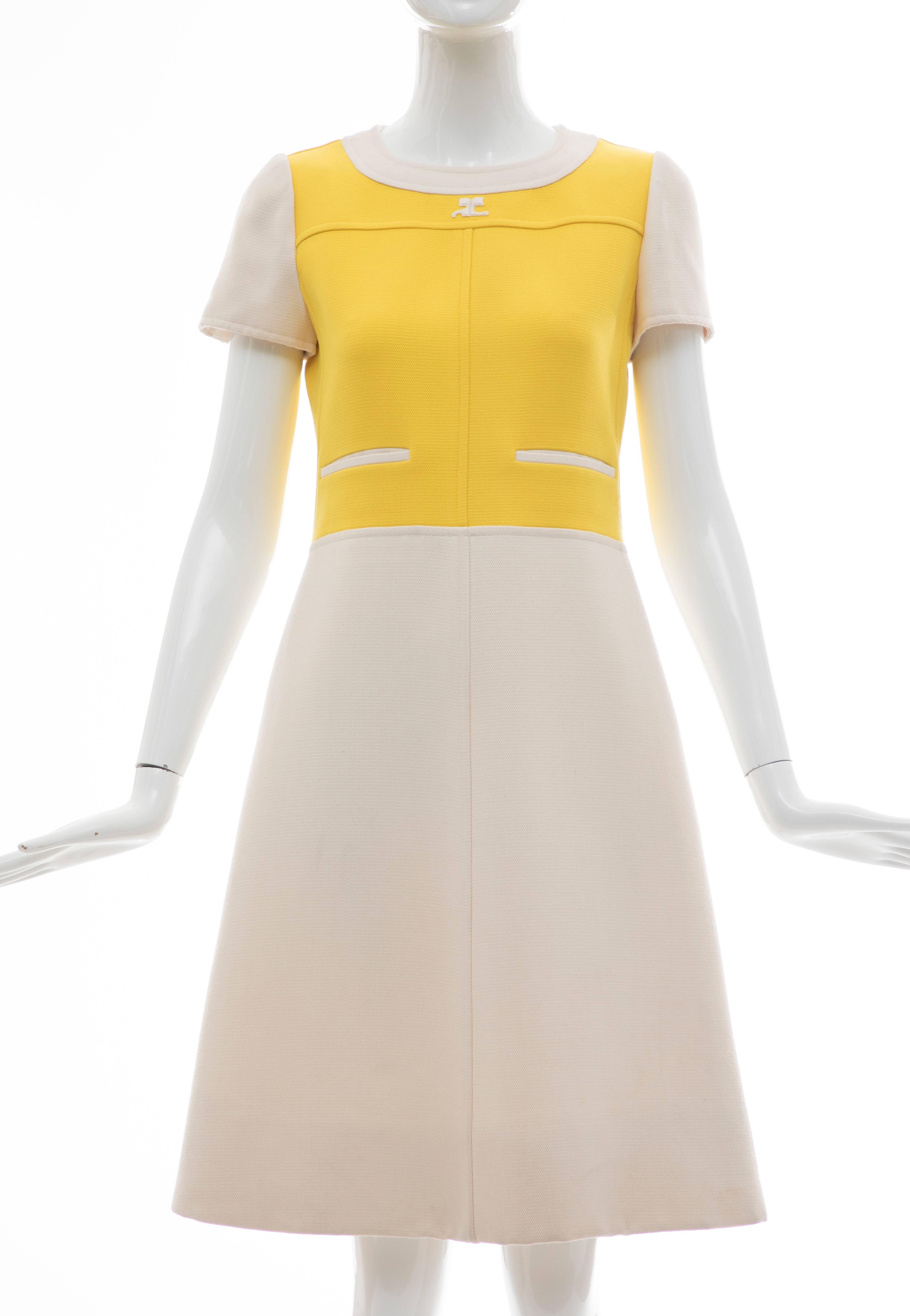 Andre Courreges, circa: 1960's  yellow cream wool cap sleeve A-Line dress with back button & snap closure and fully lined.

Bust: 32, Waist: 30, Hip: 38, Shoulder: 13, Length: 38

Size A