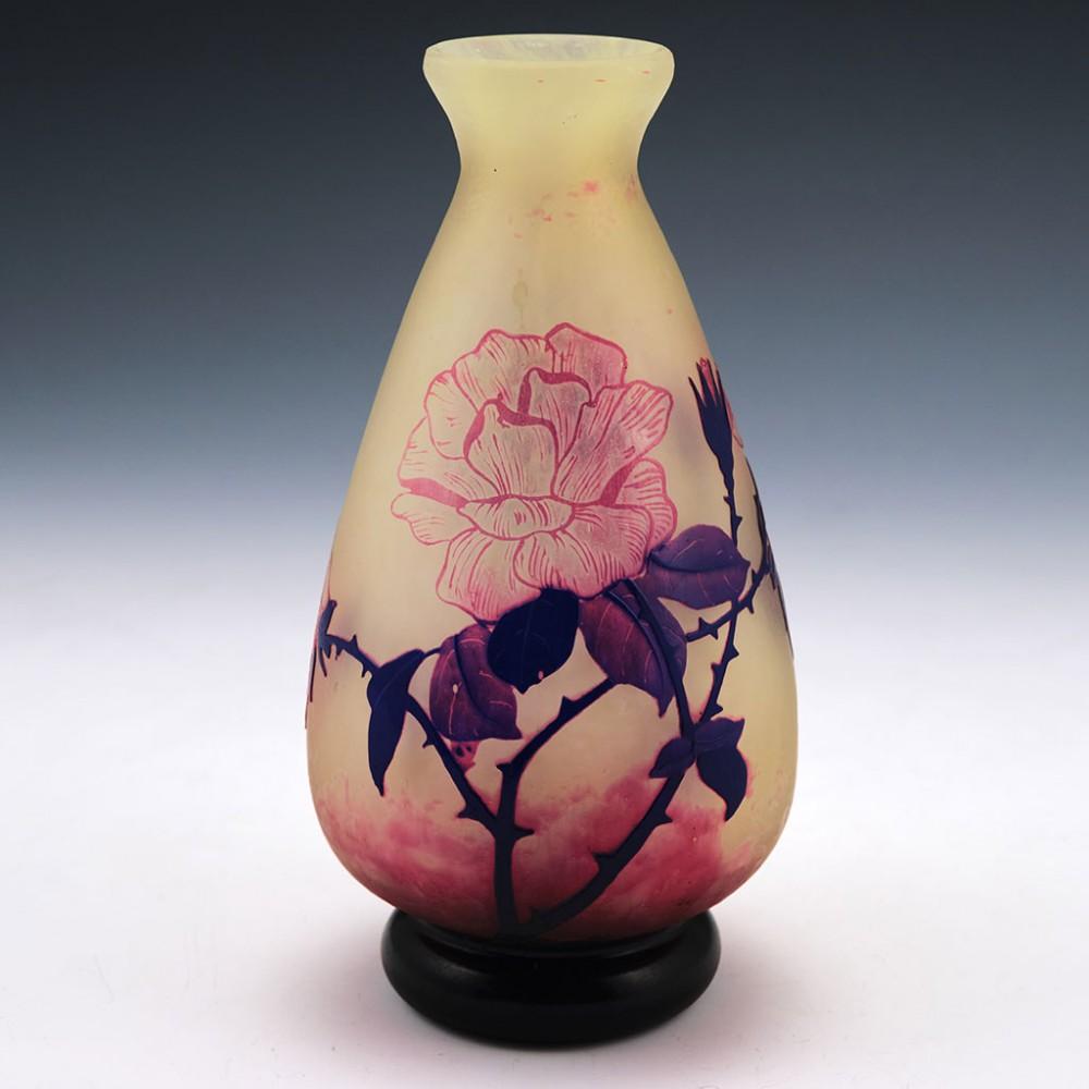 Heading : A fine cameo glass vase by Andre Delatte
Date : c1925
Origin : Jarville, Nancy, France
Colour : Mottles white and pink ground. Indigo blue base and rose stems, pink roses
Bowl : Baluster shaped acid etched cameo. Cameo signed ADelatte