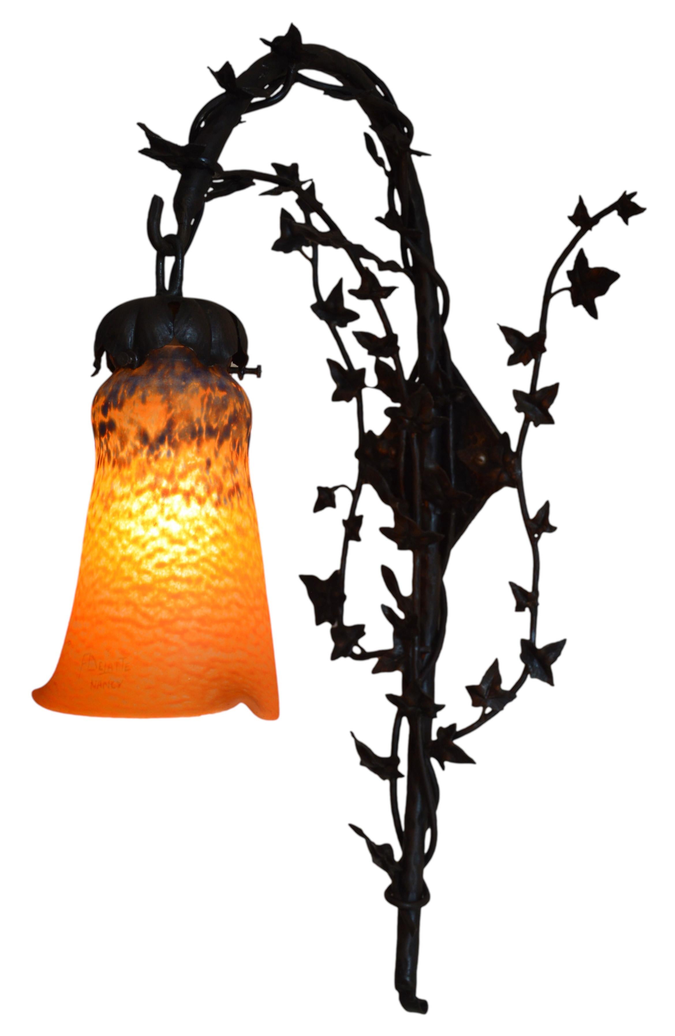 Large French Art Deco wall sconce by Andre Delatte (Jarville, Nancy), France, 1920s. Large blown double glass shade by Delatte hung at its stunning wrought-iron fixture with an ivy pattern. Height : 19.7