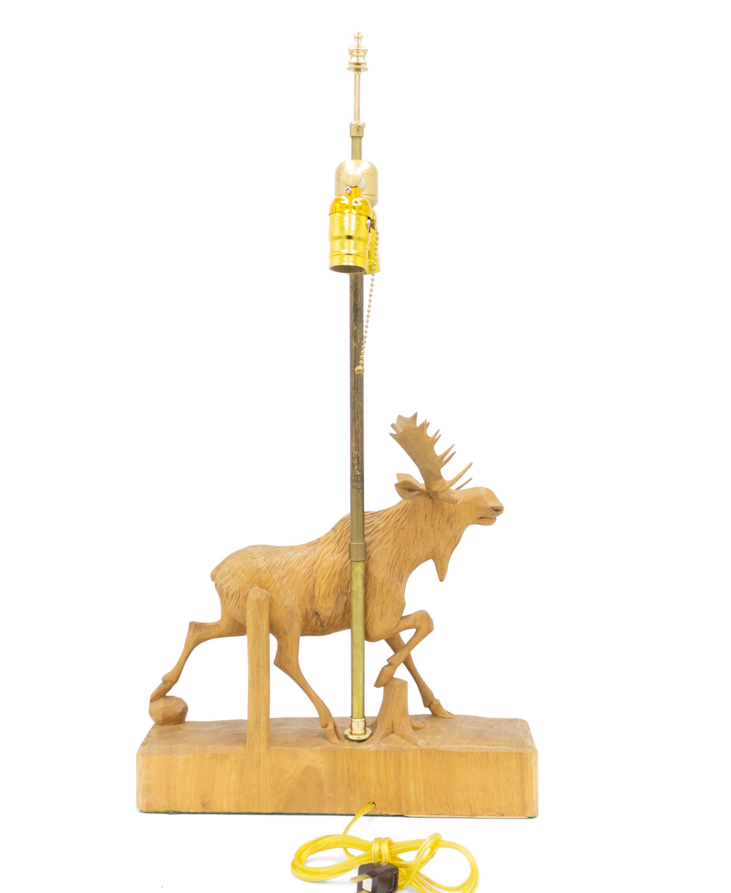 Rustic Adirondack style carved wooden figure of a moose mounted as a table lamp on a rectangular base (signed: Andre Dube).