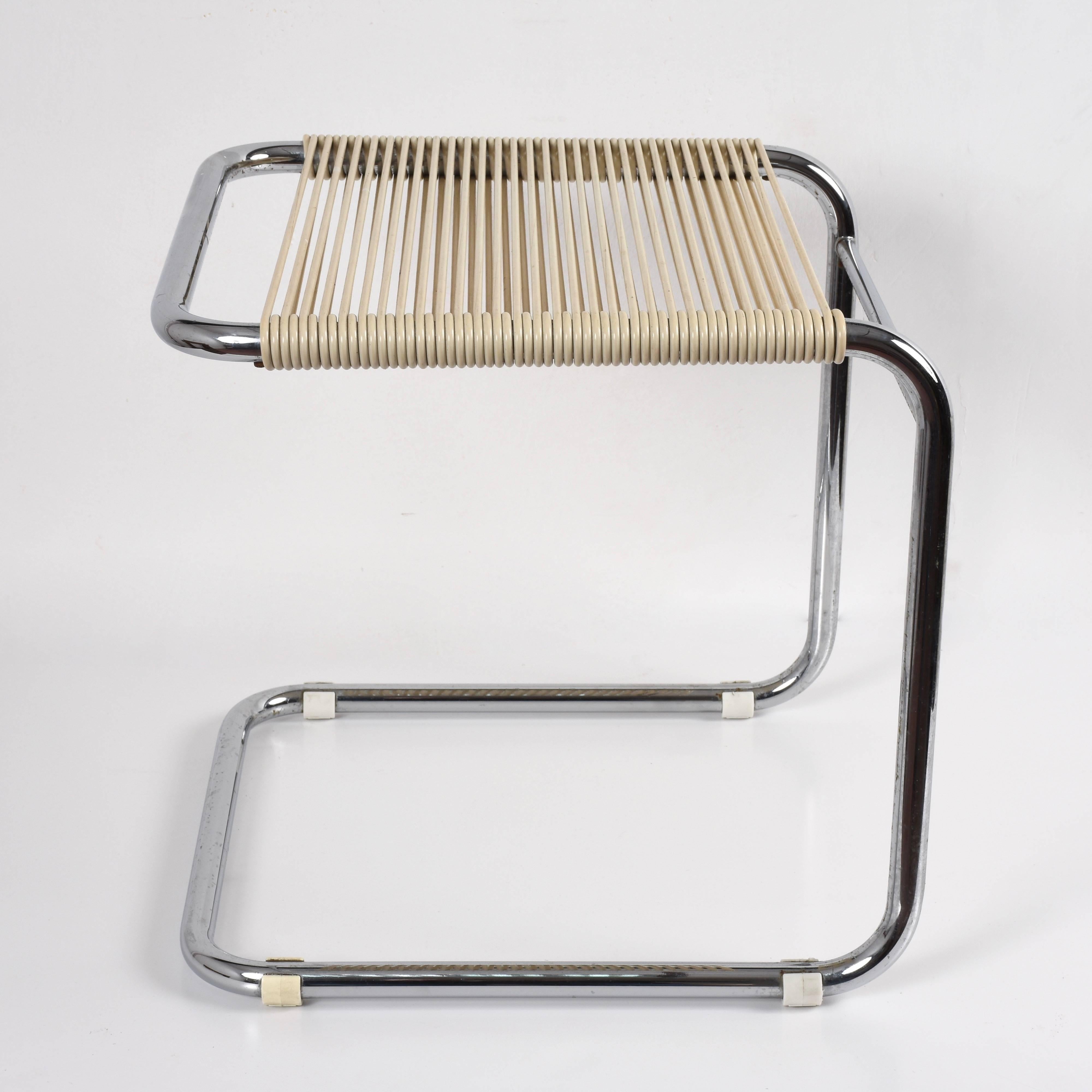 Wonderful midcentury chromed tubular steel and white plastic stool. This amazing item was designed by Andre Dupre and produced by Knoll during 1960s.

This polyhedric item could be used as a stool or ottoman and would look great in any room. Cool,