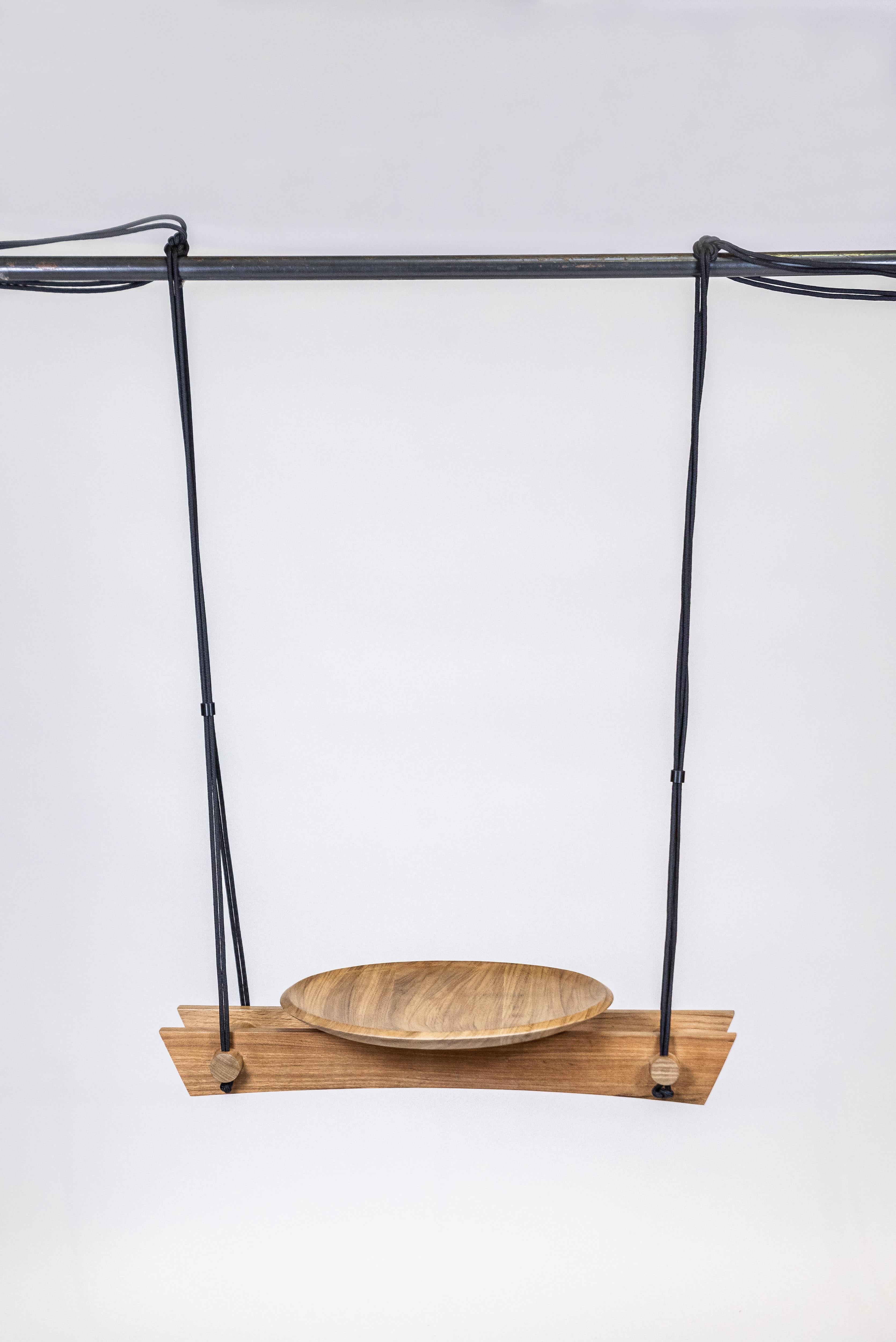 With this finely crafted swing made of Freijo wood, rope and brass, Andre Ferri gives a touch of originality while remaining in his poetic universe of suspended pieces. A touch of lightness, a reminder of childhood but also a reference to the way of