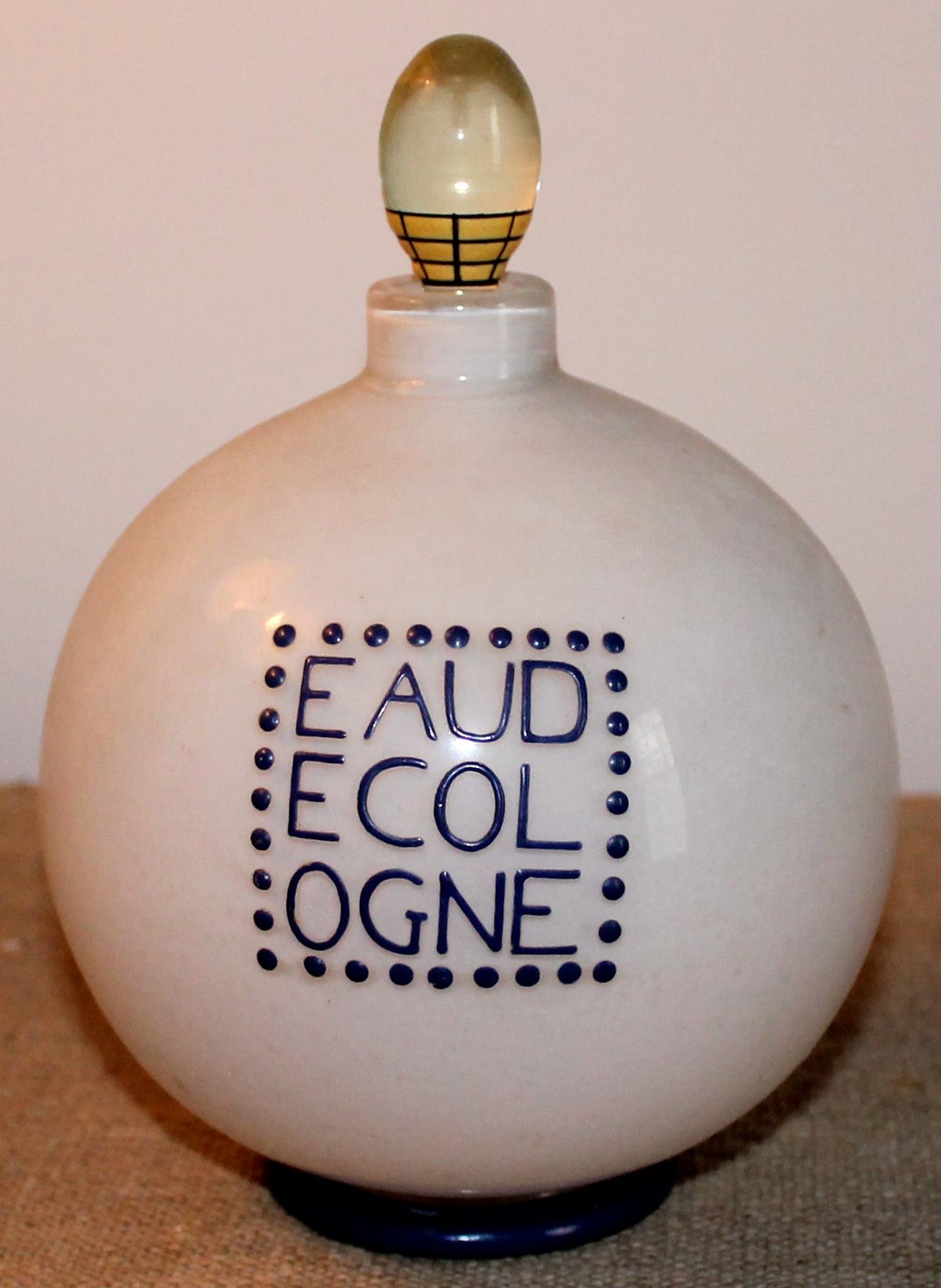 Designed by Andre Groult (1884-1966) for D;Orsay, a unique stoppered bottle hand enameled in indigo and signed with Groult's mark on the bottom. A round incased white under clear glass bottle, with the original glass stopper. Blue glass indigo foot.