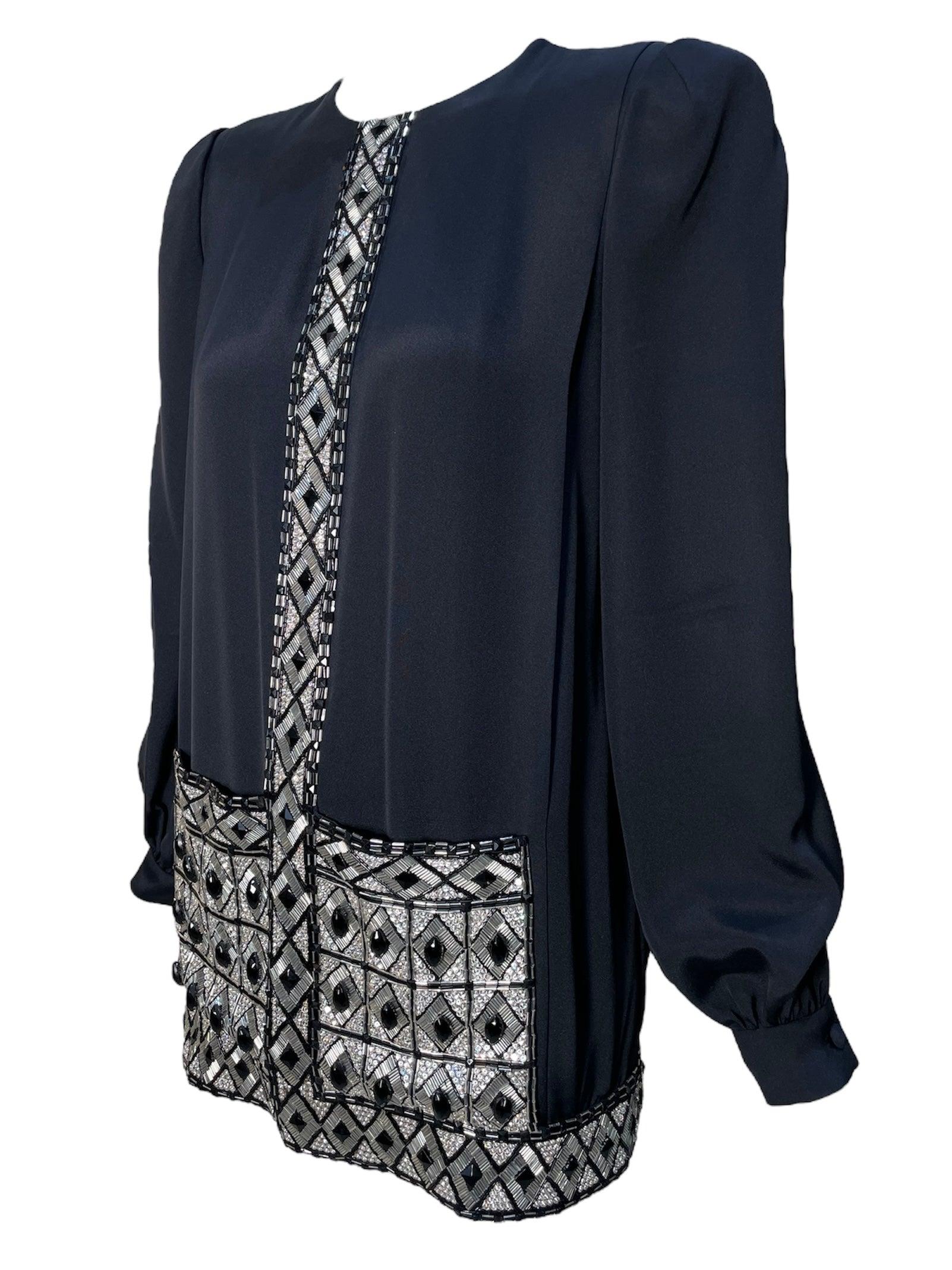 80s does '60s by André Laug. Style this with a pair of tights and your favorite boots for a sweet mini dress silhouette with some edge. Structured shoulder and gathered bracelet sleeves. Diamond geometric patterned beadwork in black and silver beads