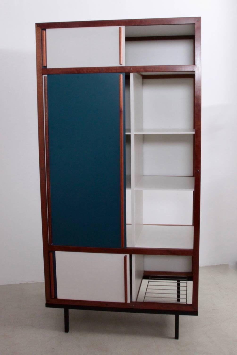 Cabinets, armoires or wardrobe by the most important Lyonaise designer of the 1930s-1950s, Andre Sornay. The wood front panels form a dynamic geometric abstraction in white, cream and petrol blue which is framed by the main structure in