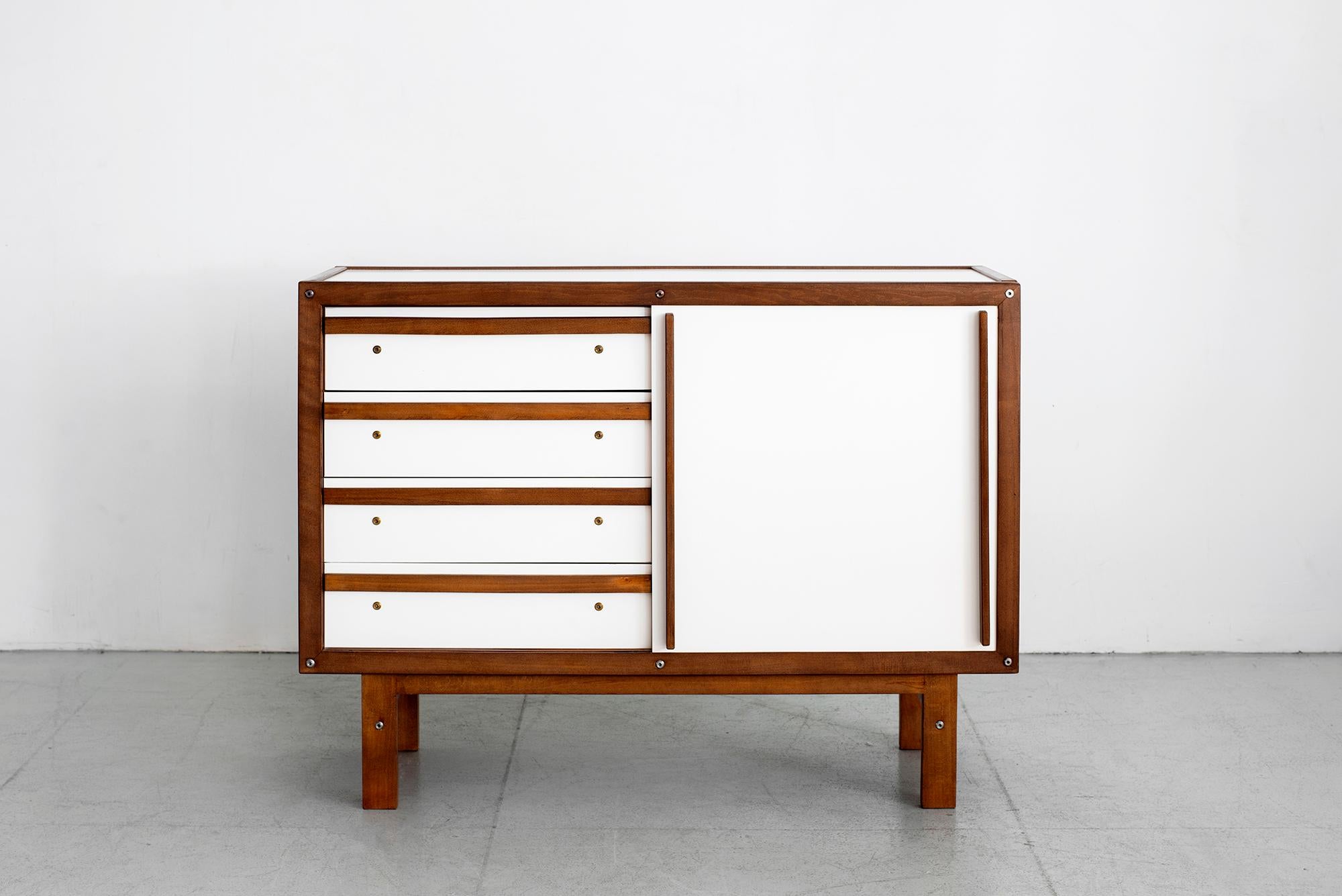 Rare dresser cabinet by French cabinetmaker Andre Sornay with white sliding door. 
Cabinet has white drawers, side and top with French Oak trim and handles. 
Sliding door revealing drawers on one side and open shelving on the other.