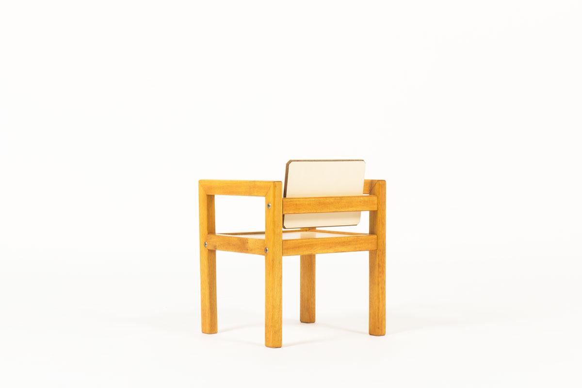 kids desk or armchair designed and manufacture by the famous French cabinetmaker Andre Sornay for an administration in France in the 60s. 
Composed of a solid wood structure, a seat and back beige laminate. 
All assembled by the tigette system