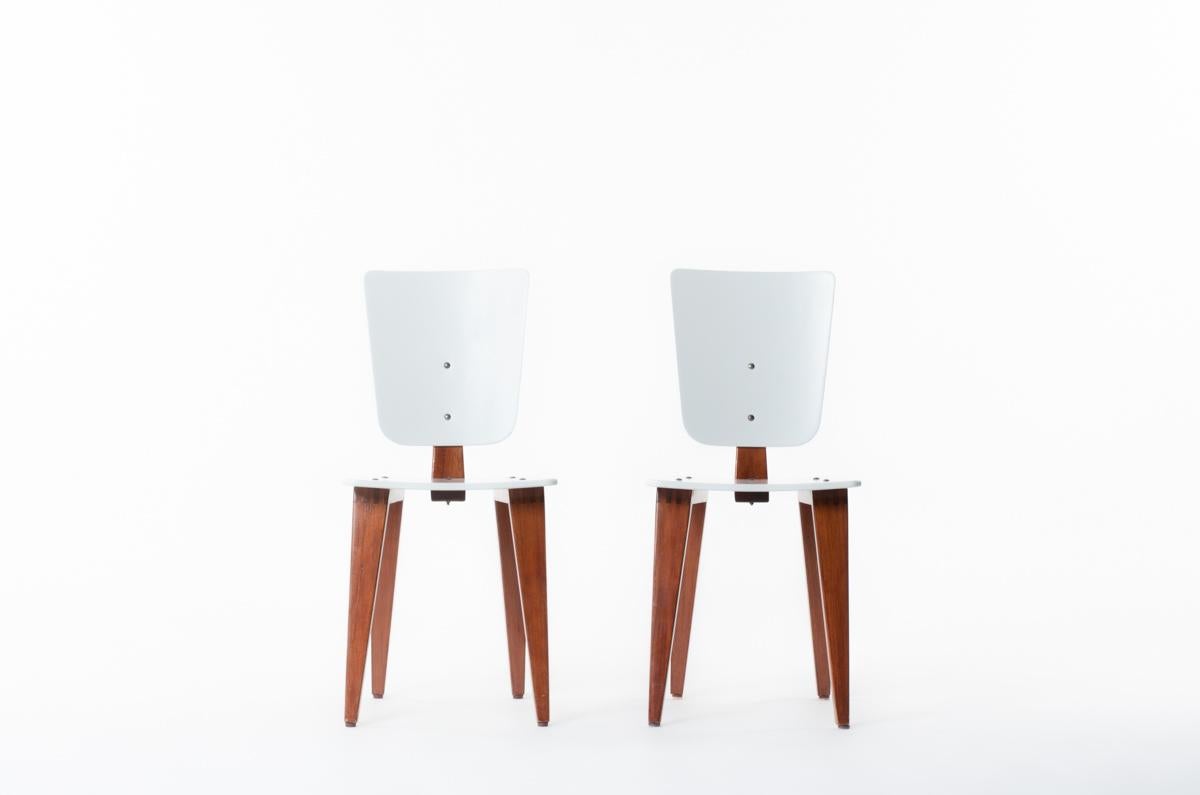 Set of 2 chairs designed by the famous French cabinetmaker Andre Sornay in 1960. 
Composed of a 4 legs base, completed by a lacquered seat and backrest, structure in wood
All assembled with original brass screws.