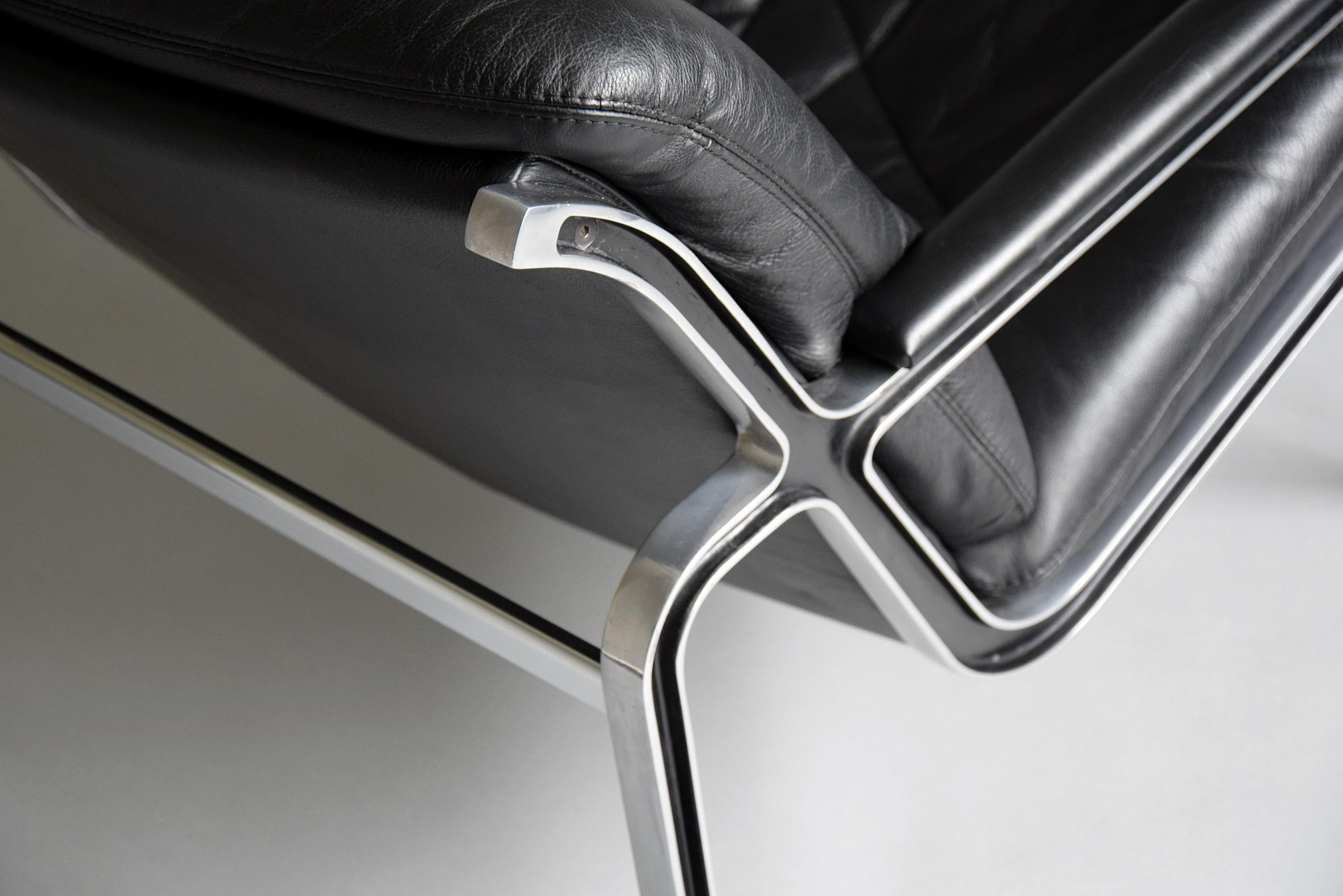 Introducing the ultimate lounge chair for the discerning collector: the 1960's Swiss high-quality designed cast aluminum and black leather Aluline lounge chair. Crafted with the highest attention to detail by Strässle International and designed by