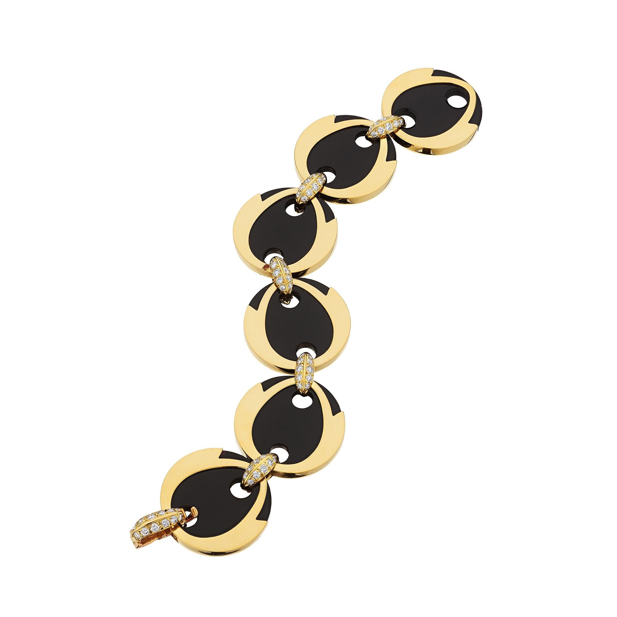With lively lyrical lines, this Andre Vassort for Boucheron diamond, onyx, and 18 karat yellow gold modernist link bracelet is mesmerizing.  Five round onyx discs stylishly framed in gold and linked with sizzling round cut diamonds, combine to make
