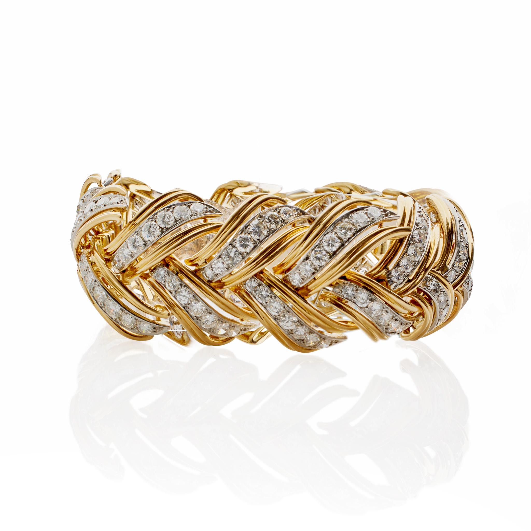 Created in the mid-20th century, this 18K gold, platinum and diamond bombé bracelet was made in Paris, France by André Vassort. Set with over 14.00 carats of diamonds, the articulated bombé bracelet is designed as a series of overlapping 18K gold