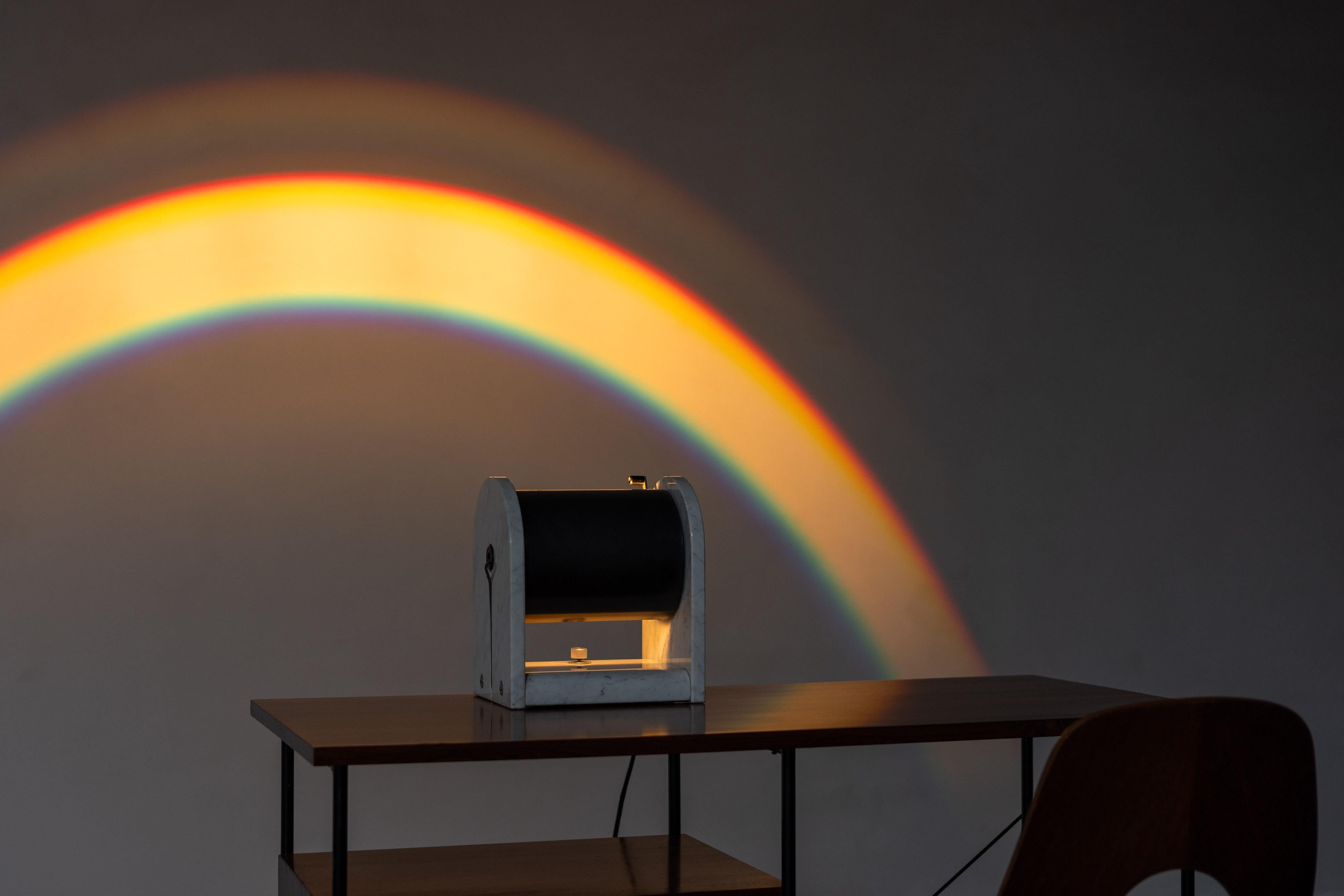 True postmodern table lamp ‘Arc en Ciel’ designed by Andrea Bellosi and manufactured by Studio Alchimea in Italy in 1978. The lamp consists of two arch-shaped sides made of Carrara marble, along with a marble base with rounded edges. Hanging in the