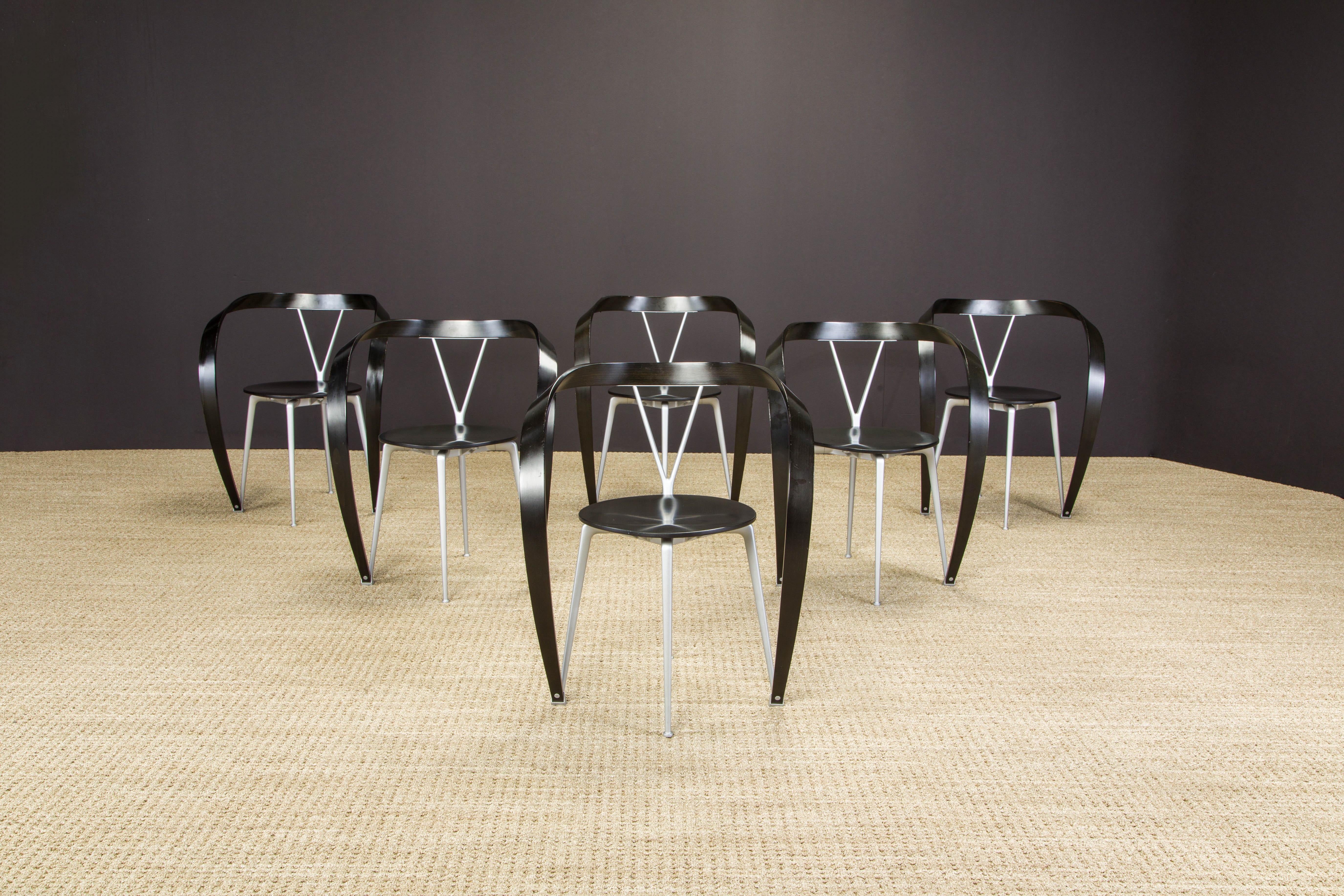 A beautiful set of six 'Revers' dining armchairs by Andrea Branzi for Cassina featuring ebonized beechwood arms sculpted in ribbon attaching to aluminum frames with matching ebonized seats. Signed with Cassina labels underneath the seats.