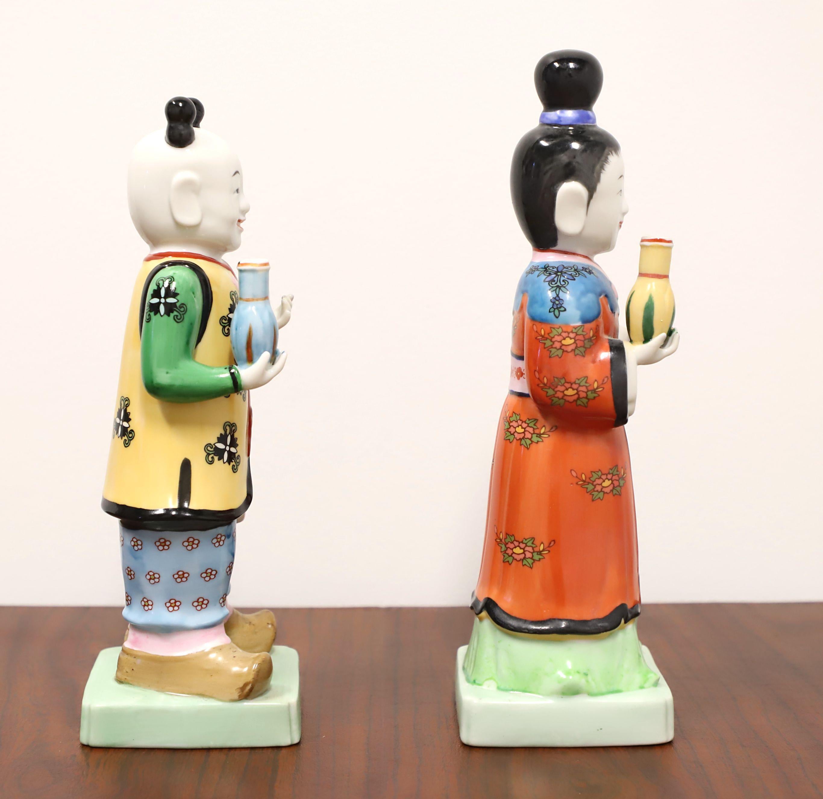 A pair of Asian style figurines depicting a traditional Chinese couple by Andrea by Sadek. Hand painted, multi-color glazed porcelain. Made in Japan, in the late 20th Century.

Measures:  Male: 3.75w 4d 11.25h, Female: 3.75w 4d 12h, Weighs