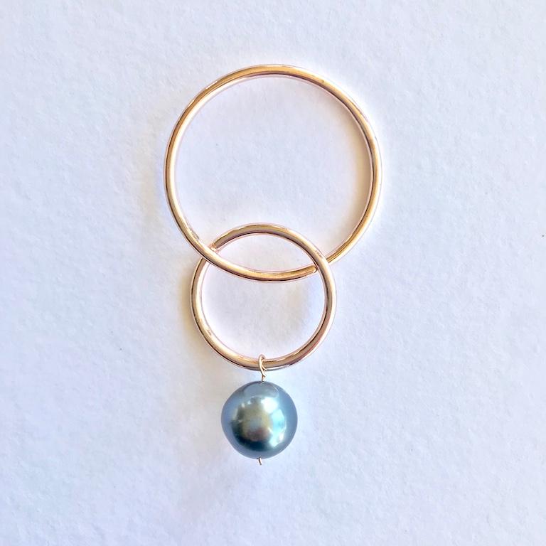 Andrea Estelle 14 karat gold hoops with tahitian pearl. The large hoop is 35mm in diameter and the smaller hoop is 25 mm in diameter, the tahitian pearl is 12mm in diameter. The earrings feature a stud post and butterfly. The total length of the