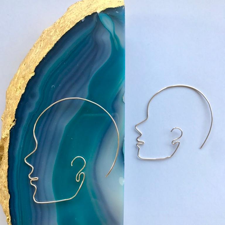 Andrea Estelle's signature wire art face profile hoops are a celebration of femininity and self love. Created by hand with a desire to celebrate and embrace each woman's own unique beauty, these earrings made in .9mm 14 Karat gold wire. They are
