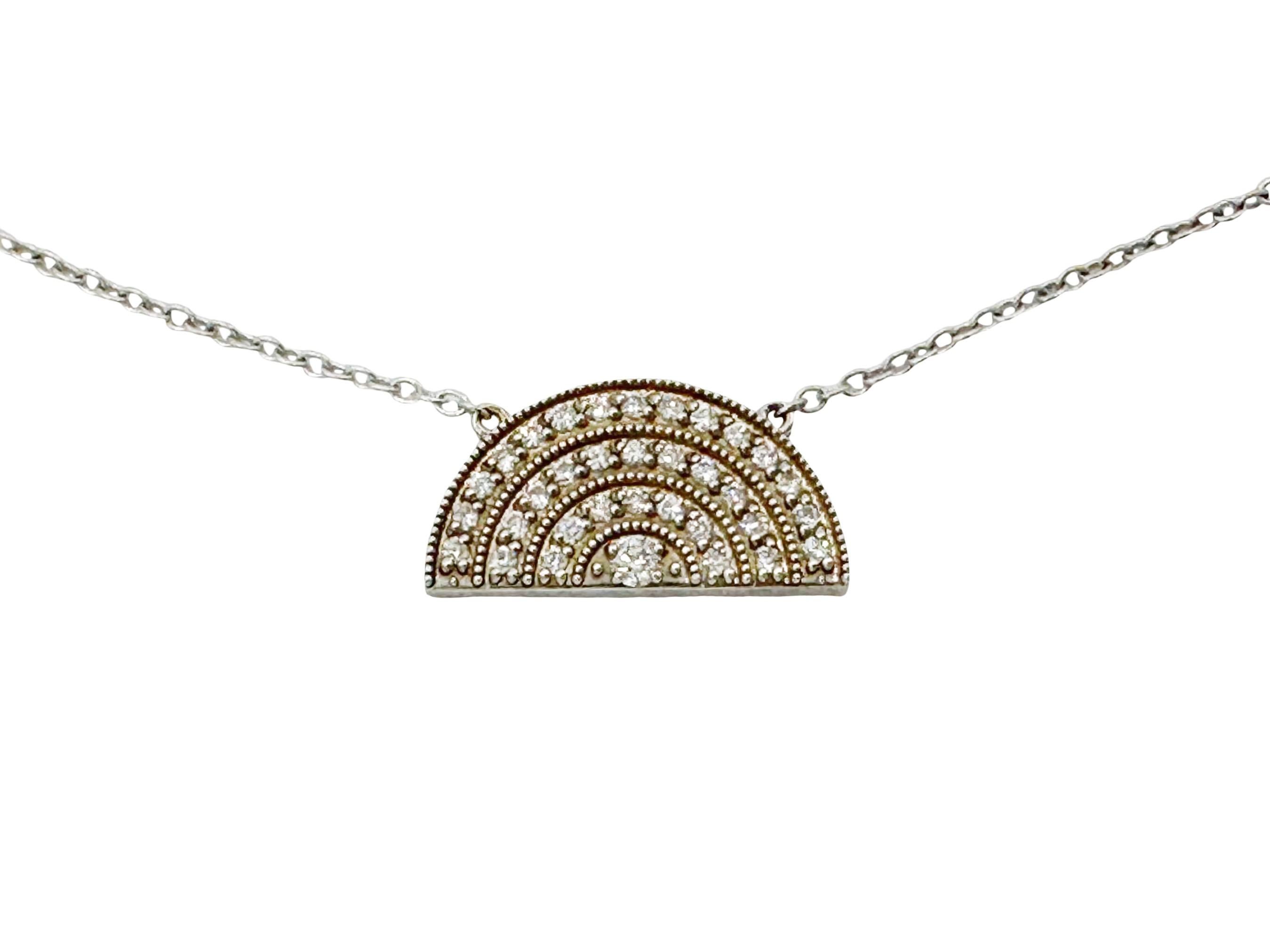 Playfully elegant, this small rainbow necklace is an Andrea Fohrman classic. Hand-wrought in 18K white gold and set with three rows of sparkling diamonds surrounding a center diamond stone, the pendant hangs from an 18k white gold rolo chain. Alone