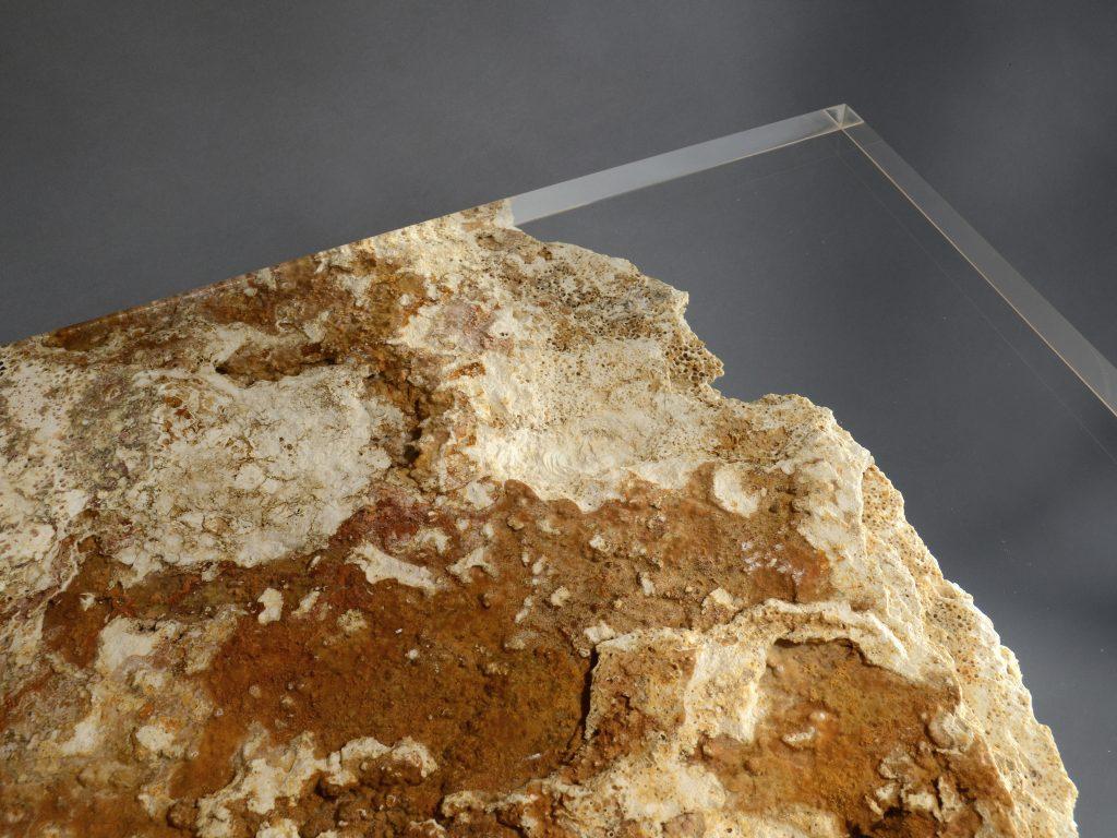 Rapolano Table is created with distinctive eroded Travertine rock, preserving its peculiar cavities marked by time using a transparent resin.