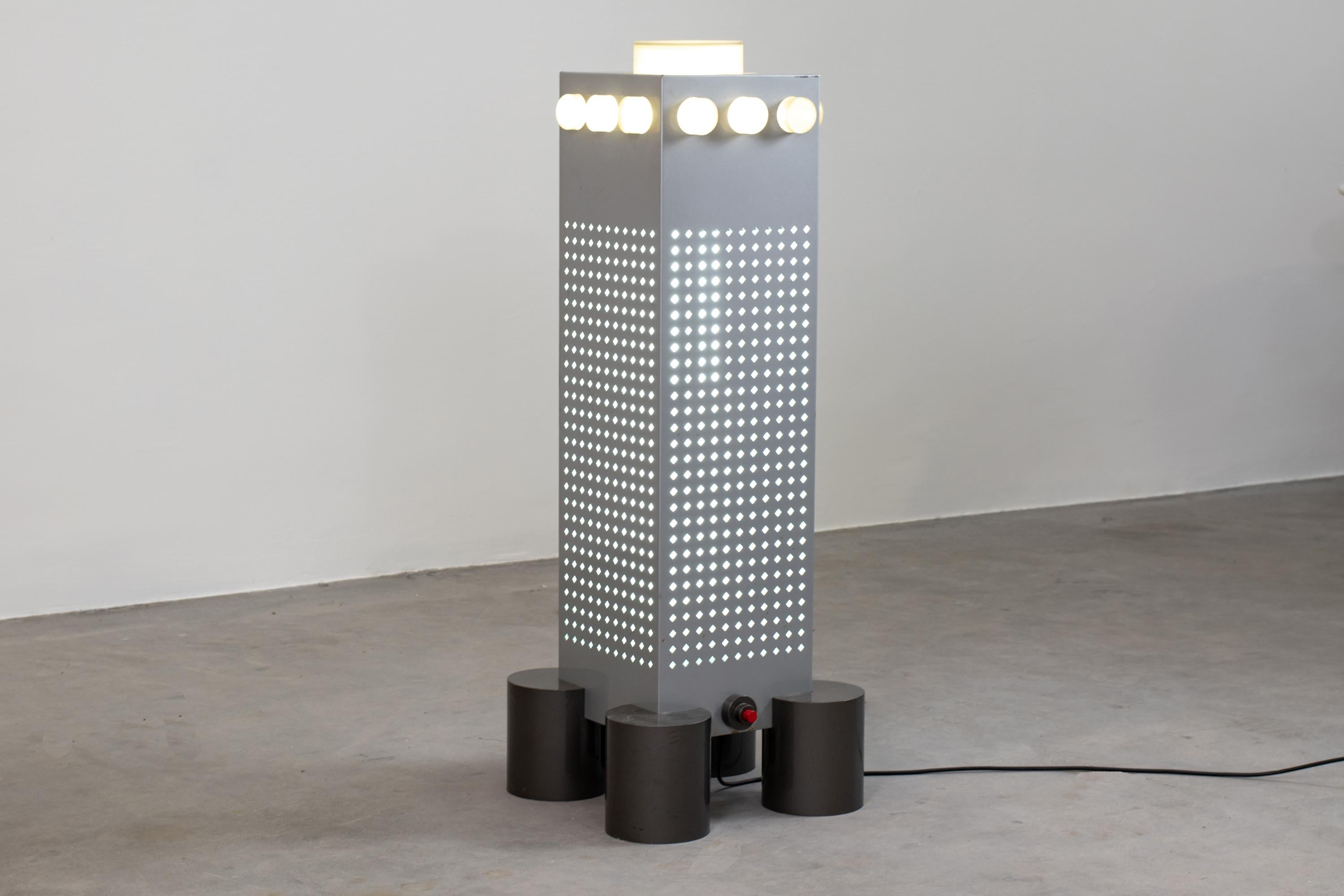 Zerodue WWF Tower floor lamp was designed by Matteo Thun and Andrea Lera in 1985 for Bieffeplast, as a part of the Stillight series, forms and signs of the fortified architecture in a table-lamp collection. 

This lamp is made out of grey-painted