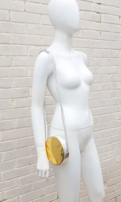 Bolso de mano Andrea Pfister con disco de cuero dorado y plateado, años 80