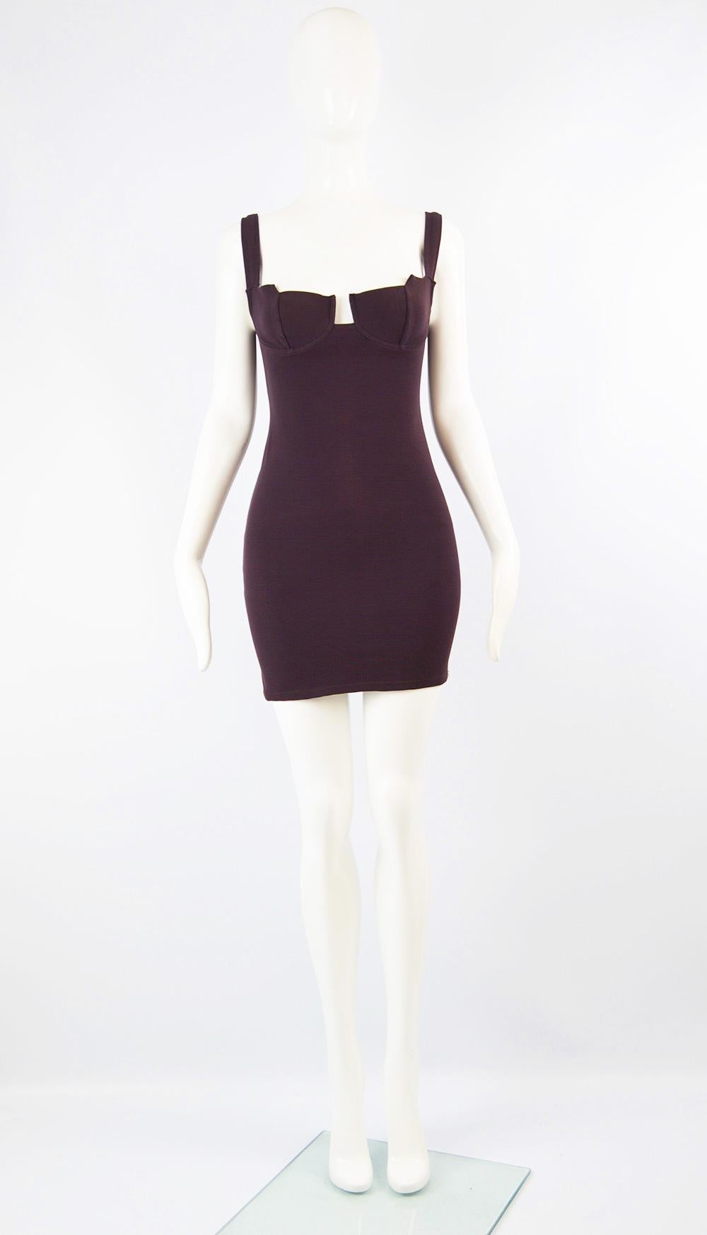 A sexy and chic vintage women's mini dress from the 90s by high quality but little known French fashion designer, Andrea Templer. In a dark aubergine colored, stretchy ribbed lycra and polyamide blend that gives a great body conscious fit which