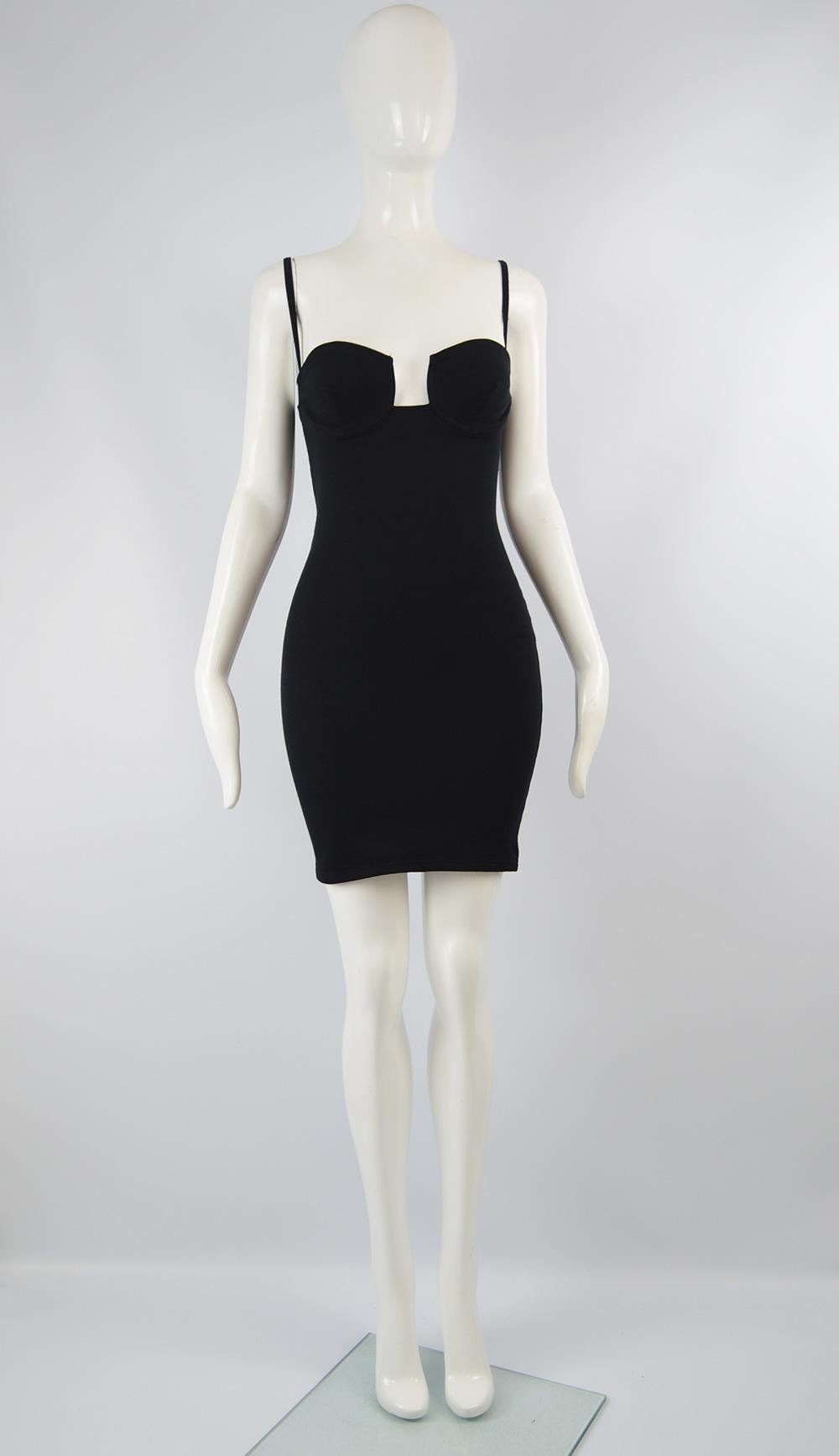 A chic vintage women's mini dress from the 90s by high quality but little known French fashion designer, Andrea Templer. In a black  stretchy lycra and polyamide blend jersey that gives a great body conscious fit. The structured bust has a plunging