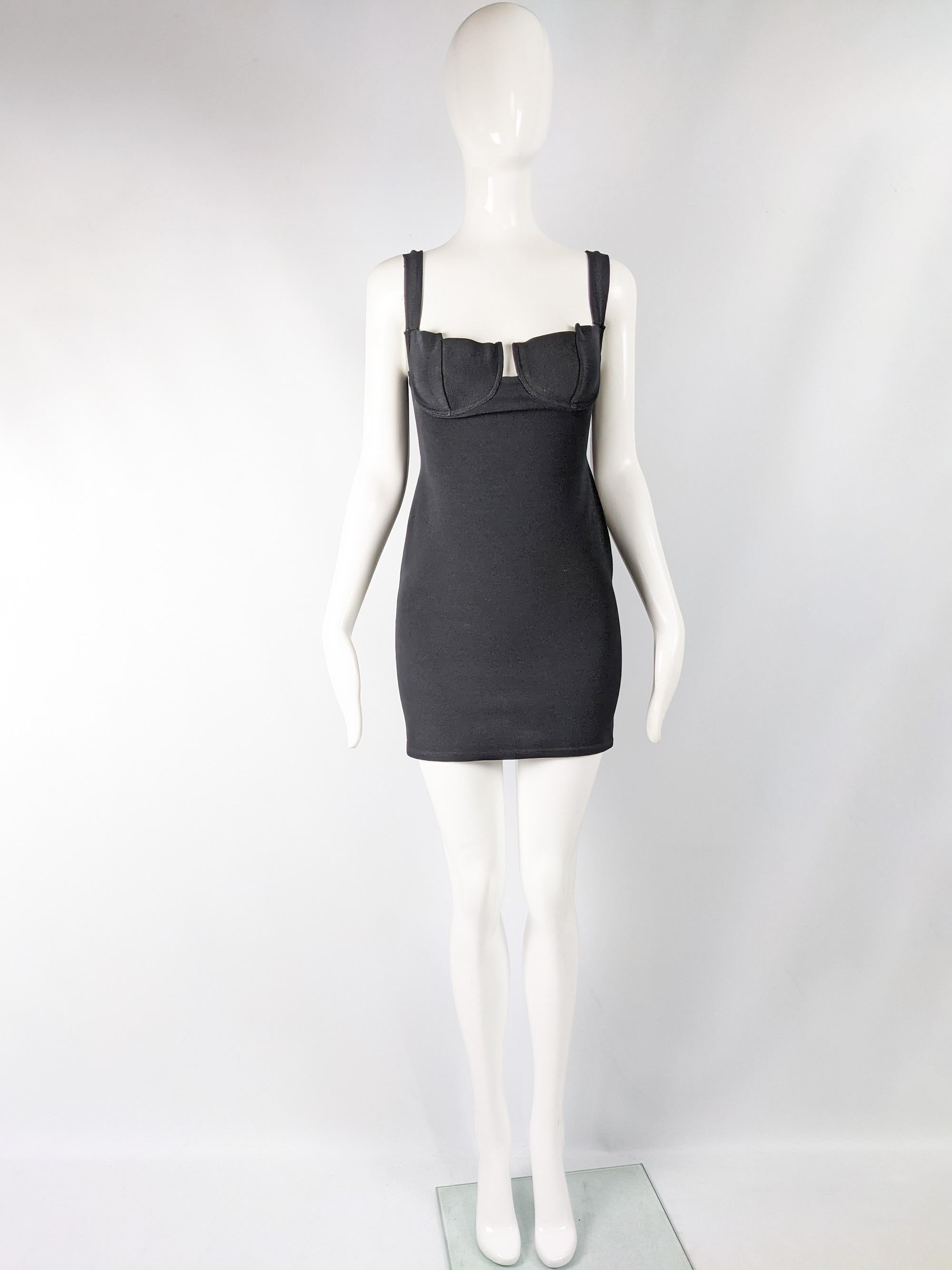 A sexy and chic vintage women's mini dress from the 90s by high quality but little known French fashion designer, Andrea Templer. In a black, stretchy ribbed lycra and polyamide blend that gives a great body conscious fit which complements the