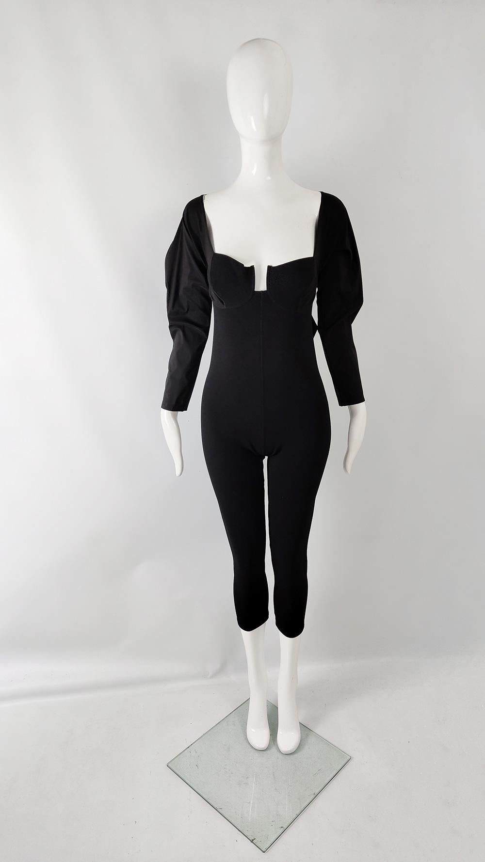 An incredibly sexy vintage womens catsuit from the 90s by luxury French designer, Andrea Templer of Paris. In a black bodycon ribbed fabric with puffed, long sleeves made from taffeta that ties around the back. It has a sculptured bust and a cropped