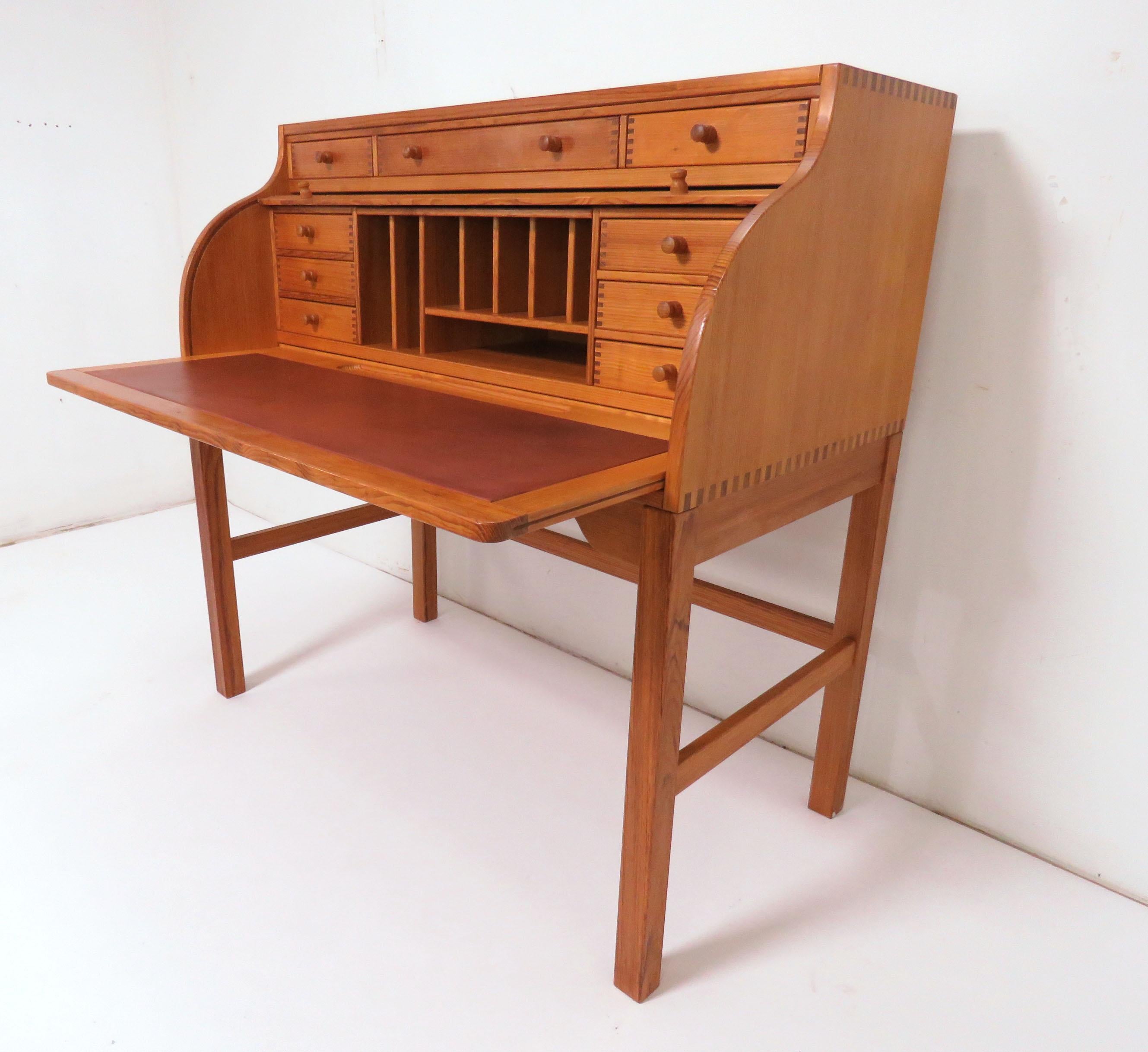 Roll top writing desk by Andreas Hansen for Hadsten Træindustri, made in Denmark, circa 1970s. Features numerous drawers and dividers and a leather-topped pull-out writing surface.

Measures 44” wide, 44.25” high. 24” deep when writing surface is