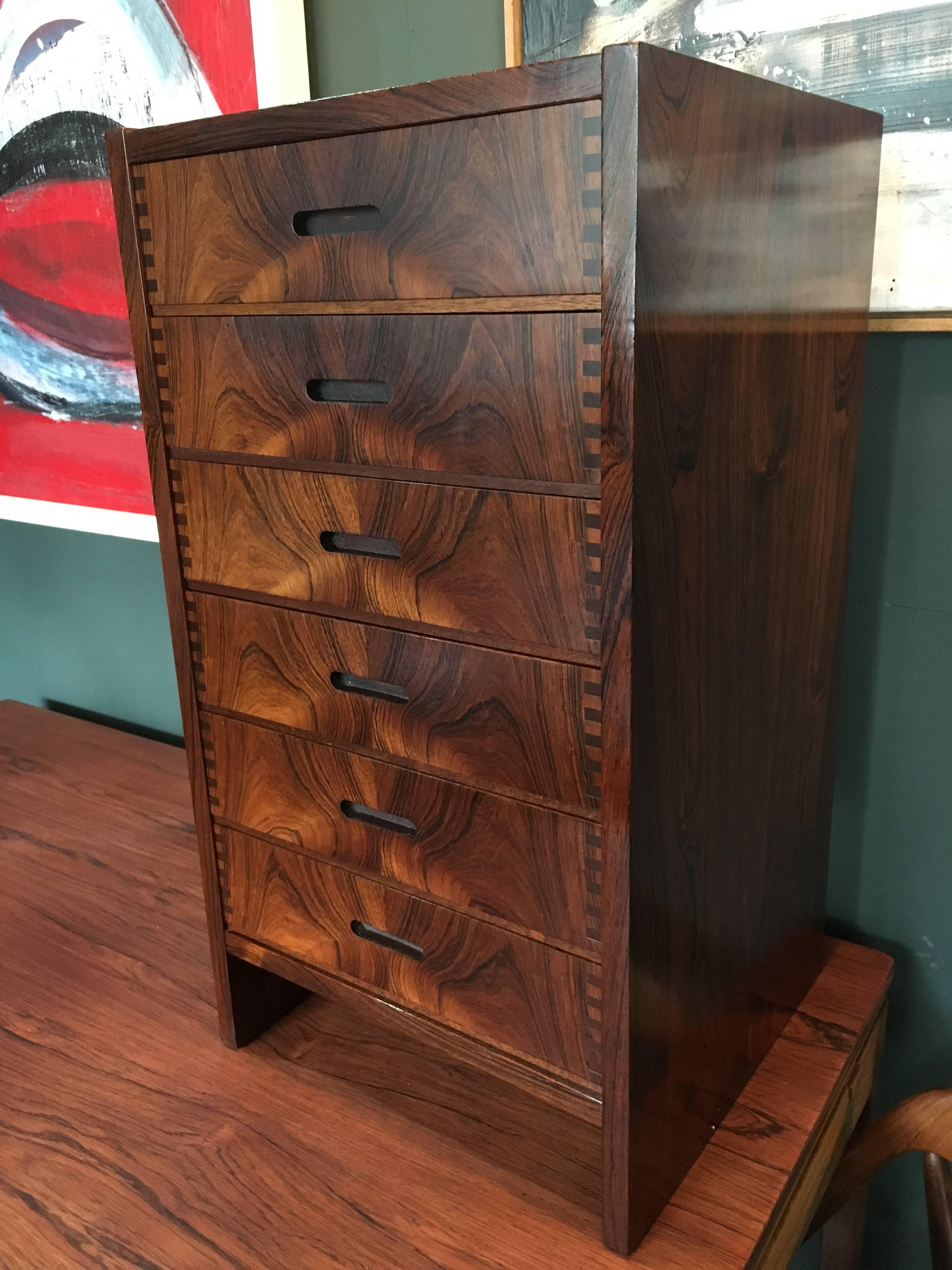 A very rare piece by Andreas Hansen. Incredibly grained solid rosewood drawer fronts with trademark Andreas Hansen joints. In superb condition throughout. Surface has been repolished. 
Original invoice with piece. A fine midcentury rarity.
 