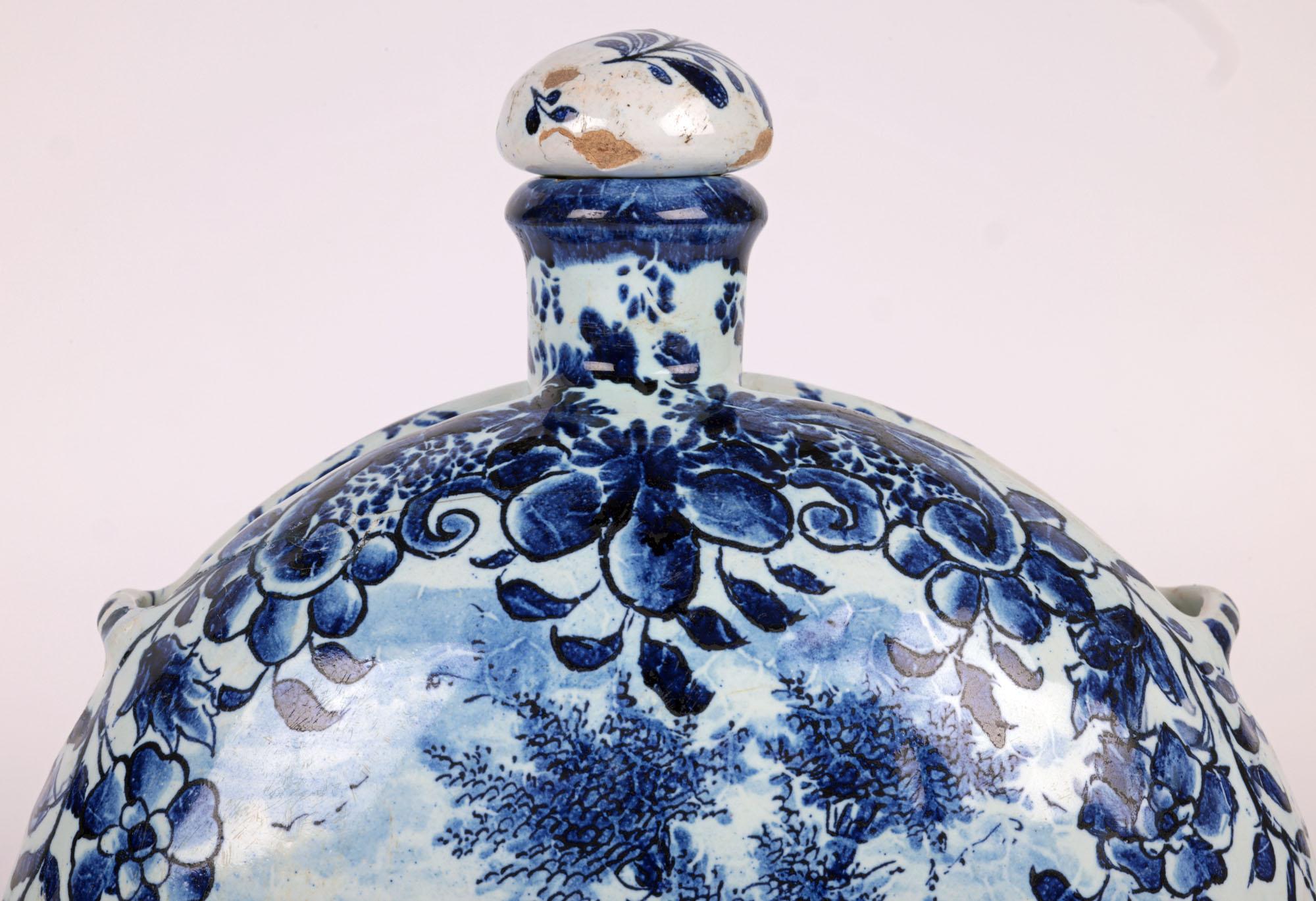 A very fine and rare German Nurenberg Delft style moon flask hand painted with a figure by Andreas Kordenbusch dated 1726. The lightly and finely potted earthenware flask stands raised on an oval shaped base the rounded body with a ridge running