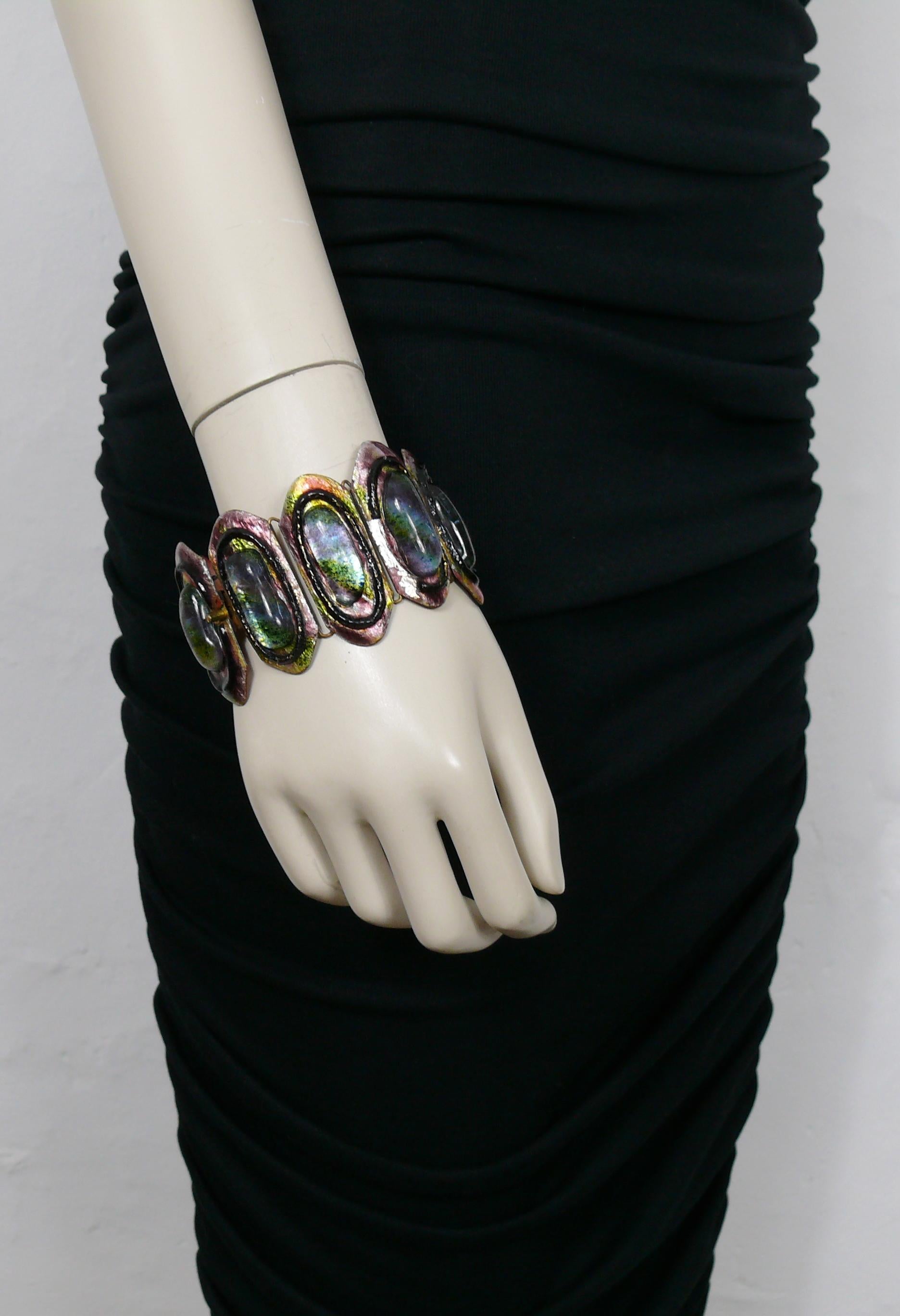 ANDREE BAZOT vintage bracelet featuring multicolored enameled links embellished with glass cabochons.

Signed ANDREE BAZOT.

Indicative measurements : circumference approx. 20.10 cm (7.91 inches) / width of the links max. 4.8 cm (1.89