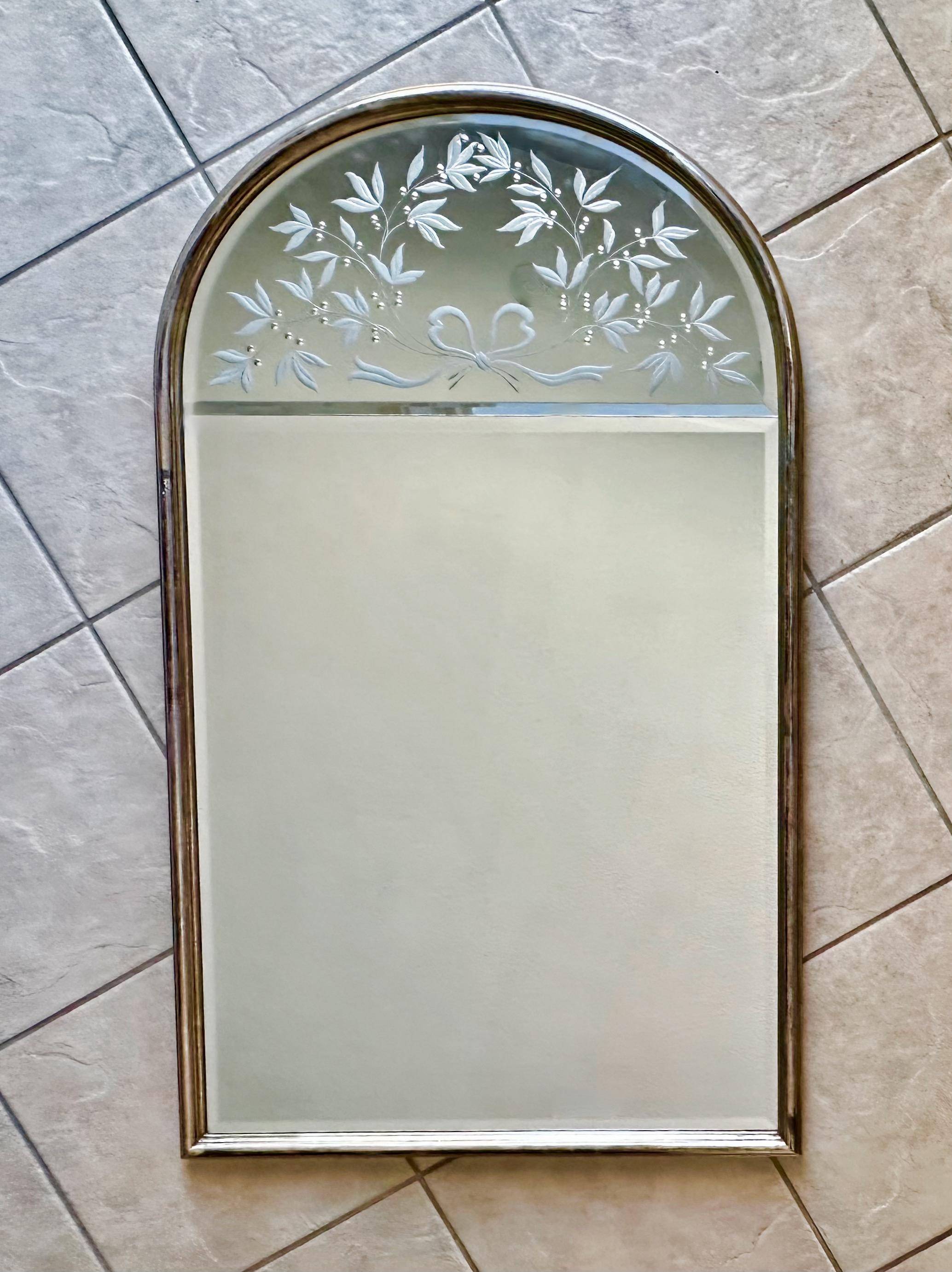 Designed by ANDREI ENZO for Labarge is an Italian arched wall mirror with antiqued silver finish wood frame. Reverse etched leaf and ribbon design. Perfect for entry or powder room. 