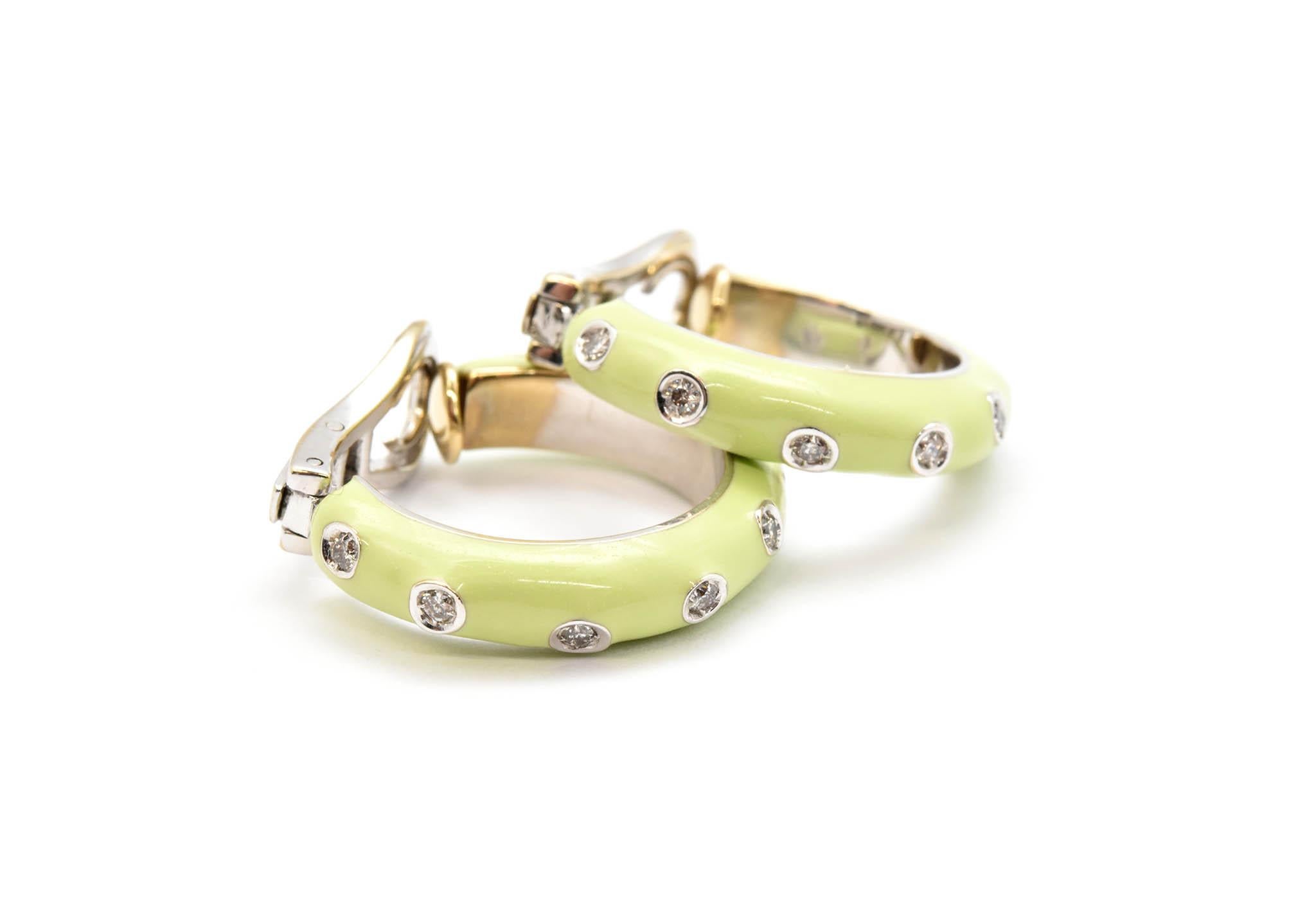 This pair of earrings is made in 18k white gold by designer Andreoli. The earrings are set with several round diamonds for a total weight of 0.36 carat. The rest of the hoops are covered in a light green enamel. The earrings measure 22mm in diameter