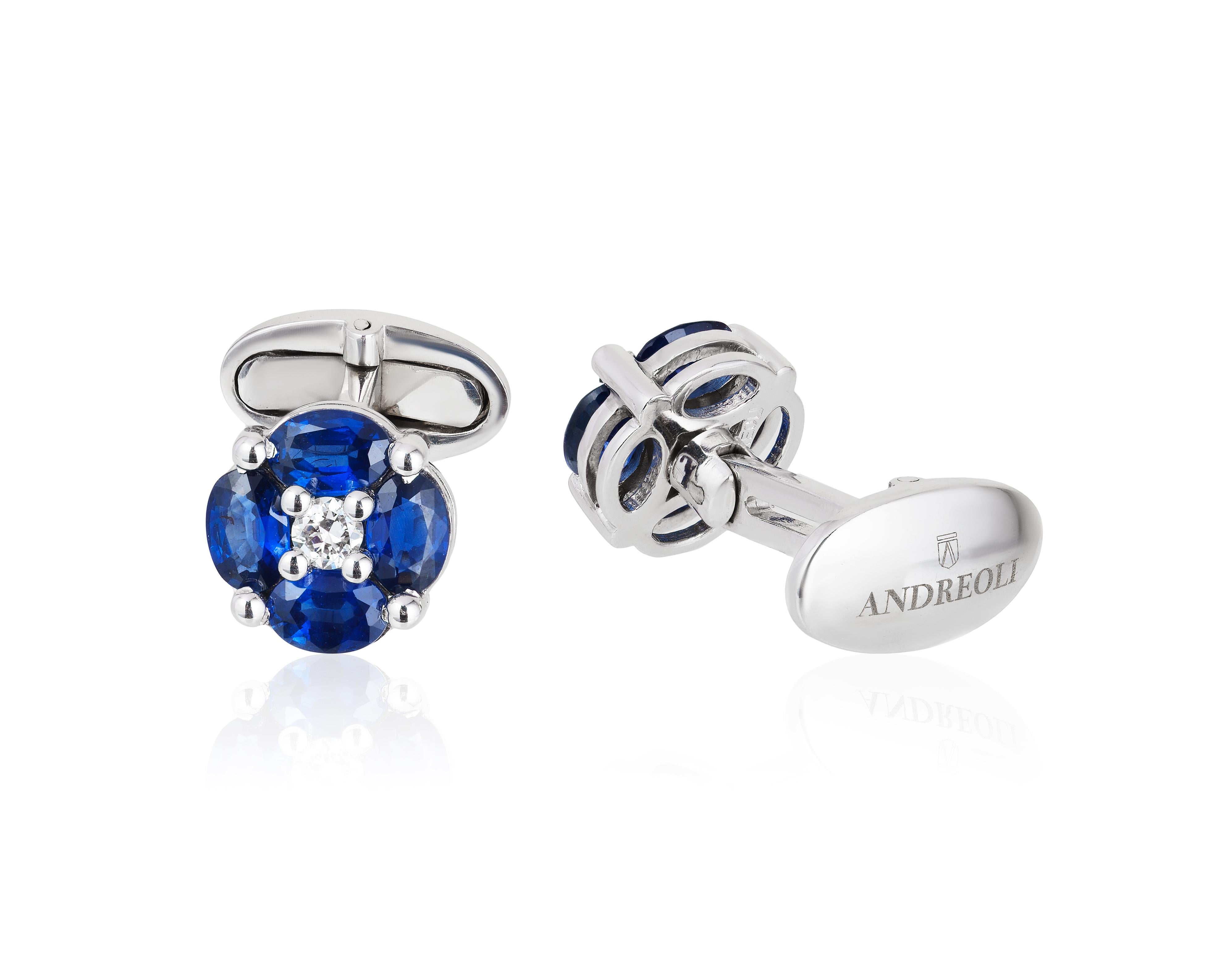 Andreoli 4.45 Carat Blue Sapphire 18 Karat White Gold Cufflinks. These cufflinks features 4.45 carats of eight oval Blue sapphires. Centered with two round diamonds weighing 0.30 carats. Set in 15.56 grams of 18 Karat White Gold. Made in the USA by