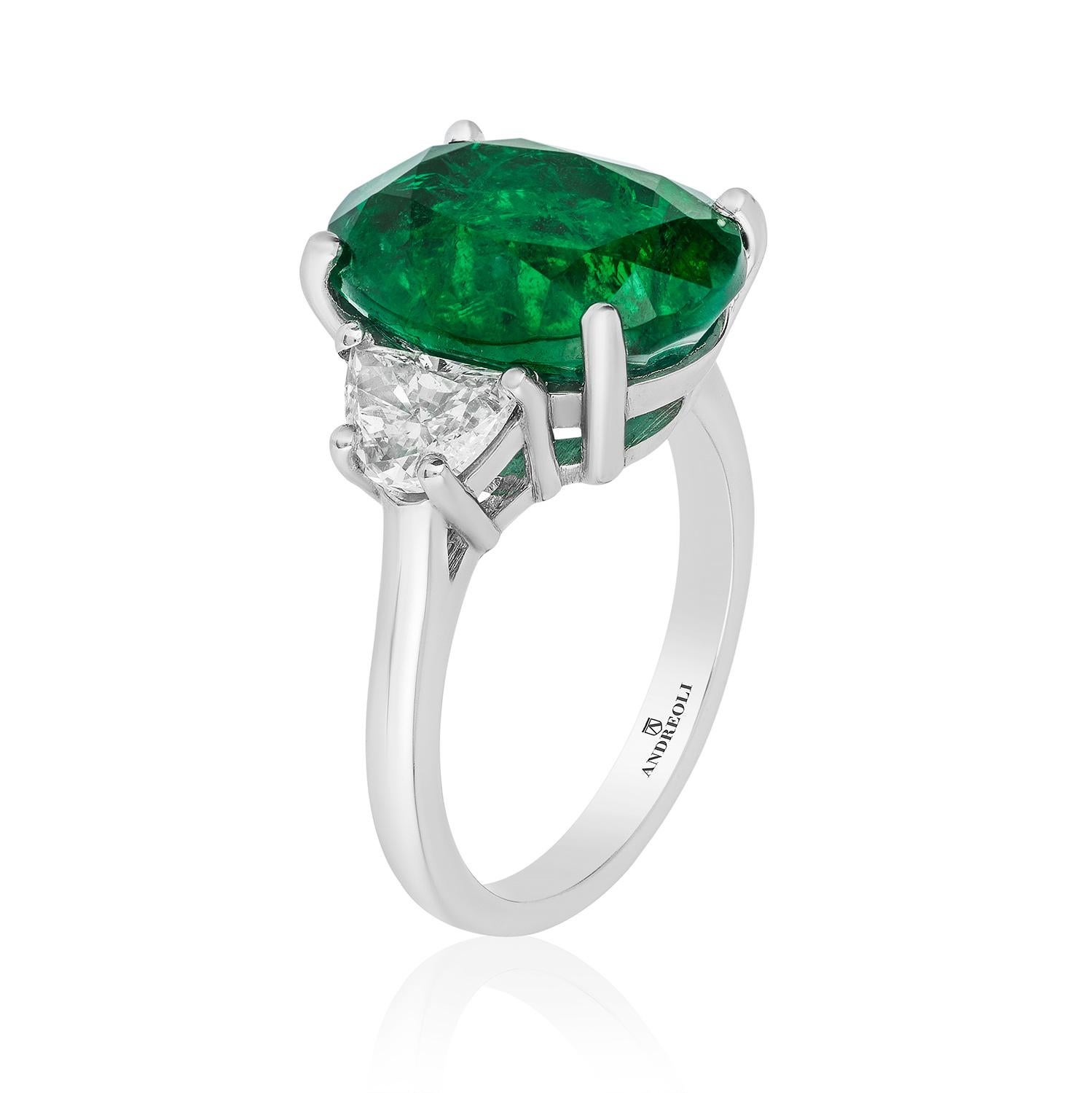 Andreoli 7.06 Carat CDC Certified Emerald Diamond Ring Platinum. this ring features a 7.06 carat vivid green zambian origin minor oil emerald certified by CDC Switzerland. Two Trapezoid diamonds 1.10 carat, Set in Platinum. Made in the USA by