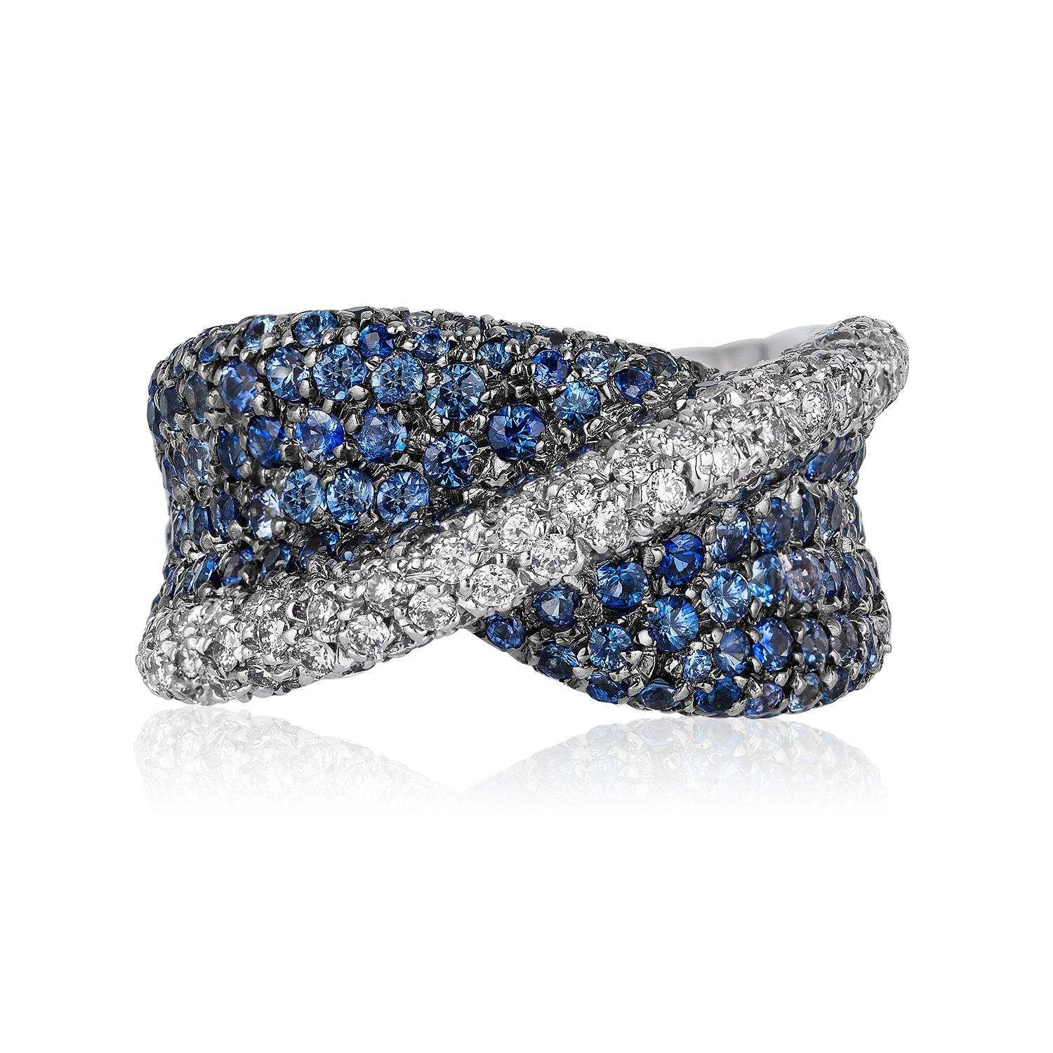 Andreoli Blue Sapphire Diamond Ring 18KT White Gold. This ring features, 3.10 carats of round blue sapphires accented with 1.17 carats of full ideal round cut brilliant diamonds. The diamonds are F/G/H in Ccolor VS-SI Clarity. The ring is set with