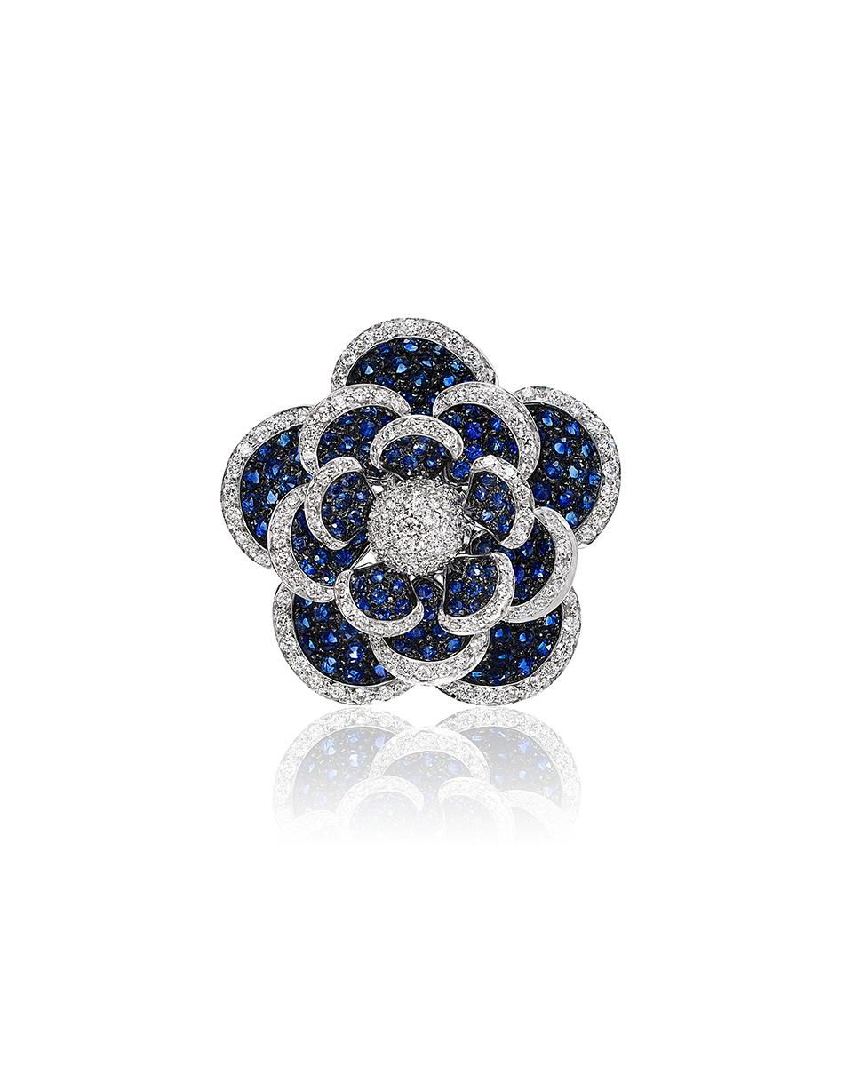 Andreoli Blue Sapphire Diamond Moving Petals Flower Cocktail Ring 18KT White Gold. This ring features 4.11 carats of round blue sapphires. Accented with full round cut brilliant diamonds weighing 1.50 carats. F/G/H in Color, VS-SI in Clarity. The