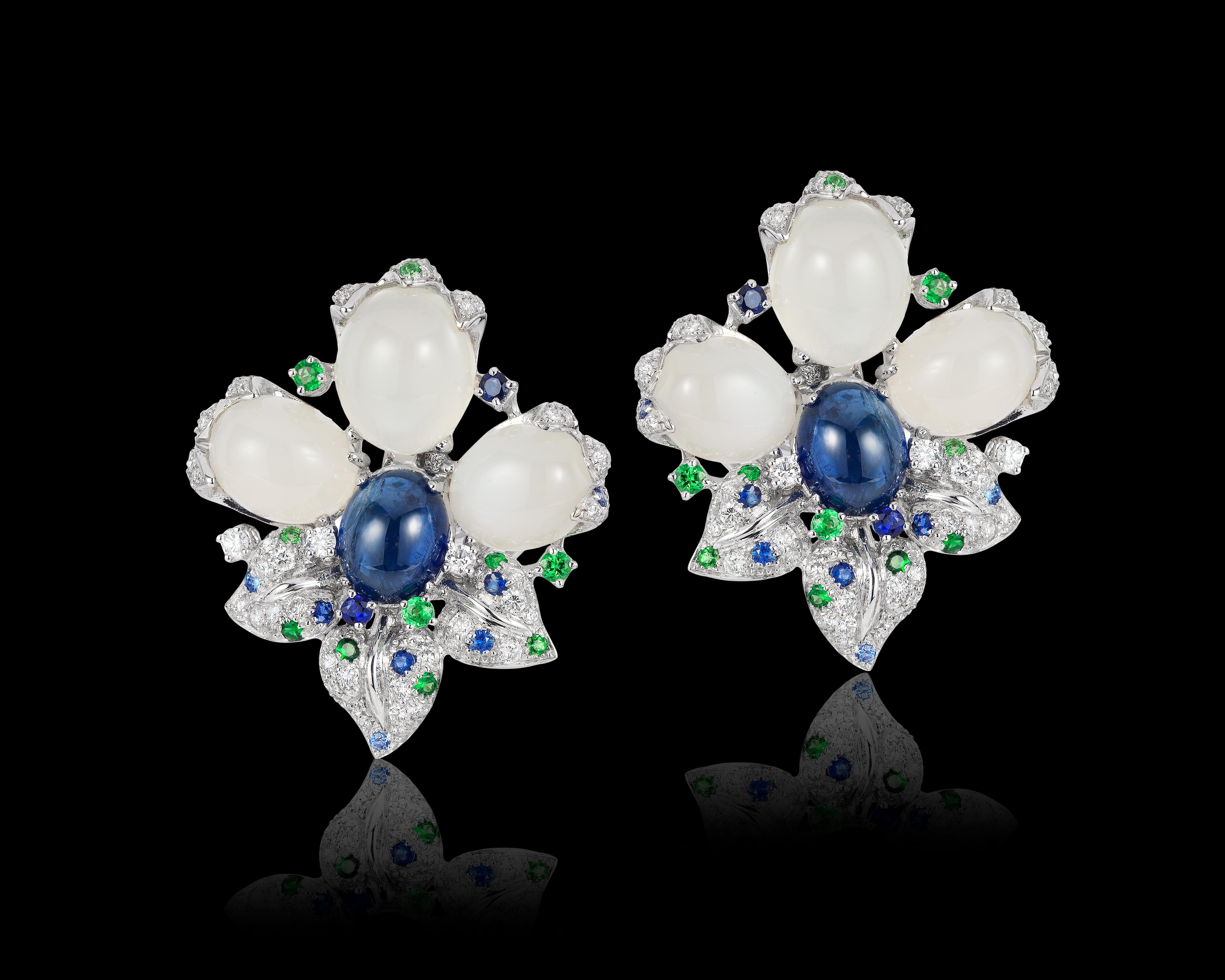 Andreoli Blue Sapphire Moonstone Cabochon Diamond Tsavorite Flower Earrings . These Andreoli earrings features 6 dome cabochon shaped oval moonstones weighing 24.57 carats. Two center dome shaped oval cabochon blue sapphires weighing 8.97 carats.