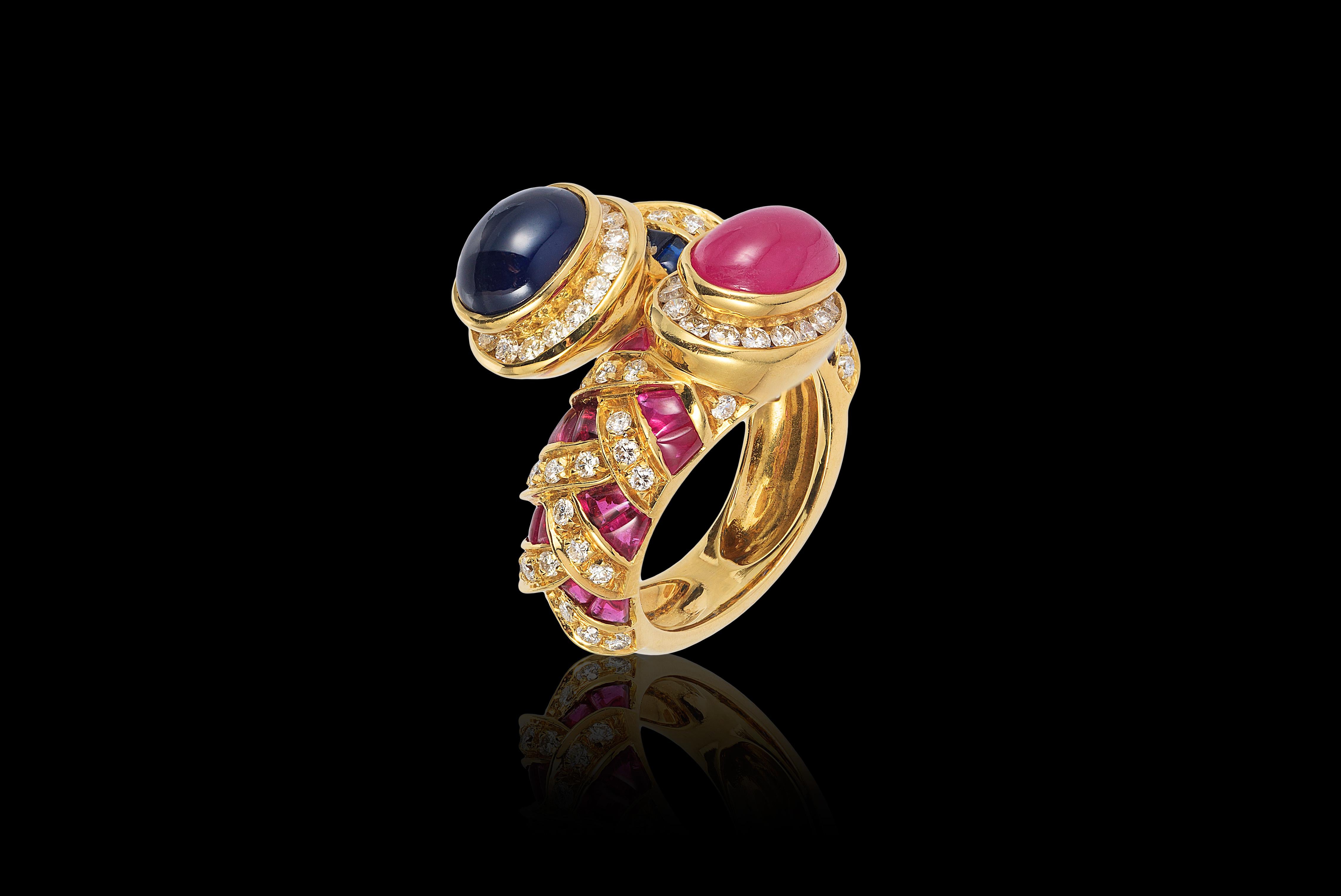 Andreoli Blue Sapphire Ruby Cabochon Bypass Cocktail Ring 18 Karat Yellow Gold. This ring features 1.12 carat of F-G-H Color VS-SI Clarity brilliant full round cut diamonds. 4.94 carat Blue Sapphires, 3.72 carat Ruby and set in 16.20 grams of 18