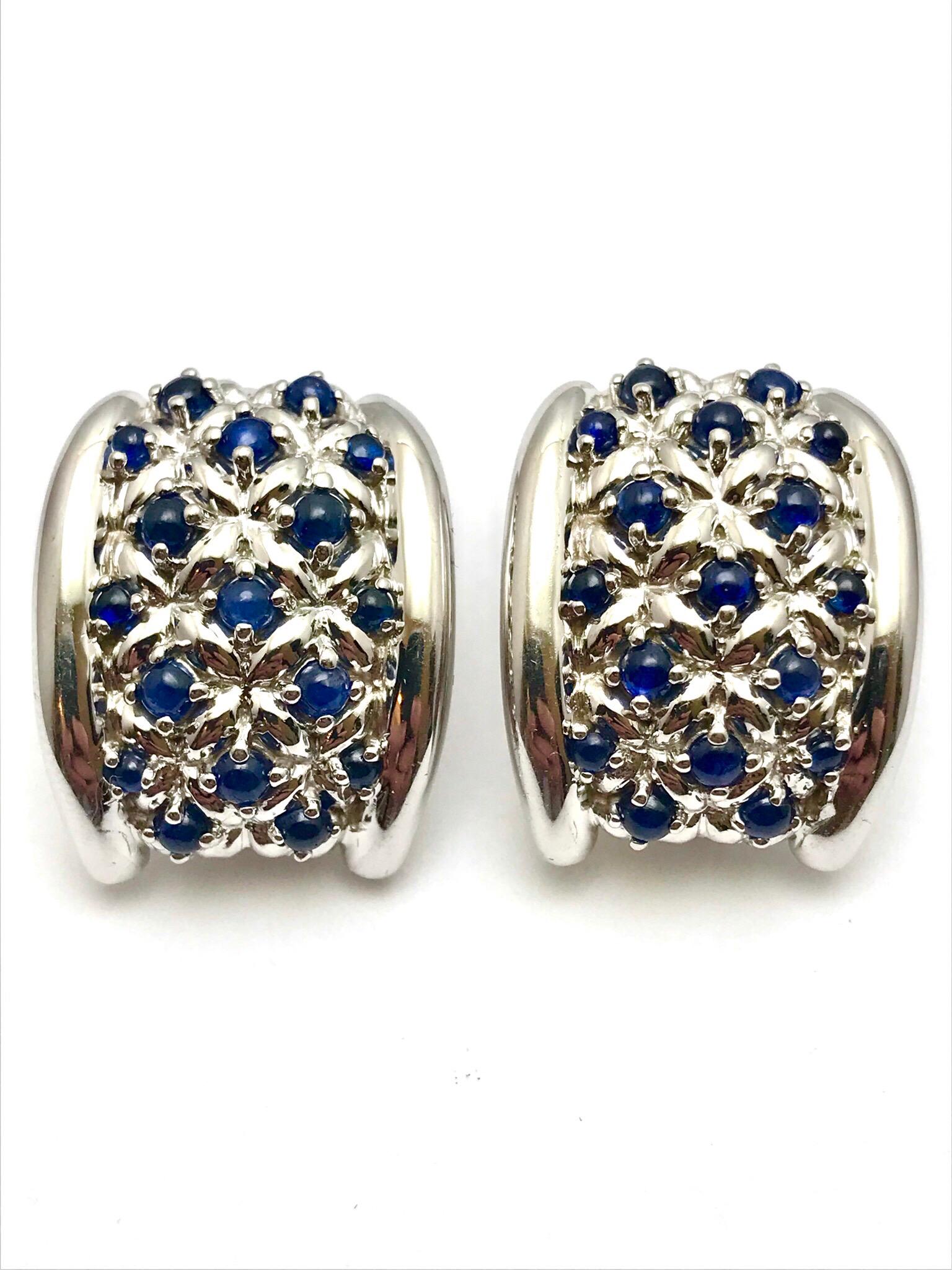 A pair of cabochon sapphire and 18 karat white gold clip/post earrings designed Andreoli of Italy.  Each earring contains 17 sapphire combining for a total weight of 1.70 carats.  The sapphire are prong set on a slightly curved surface with a fold
