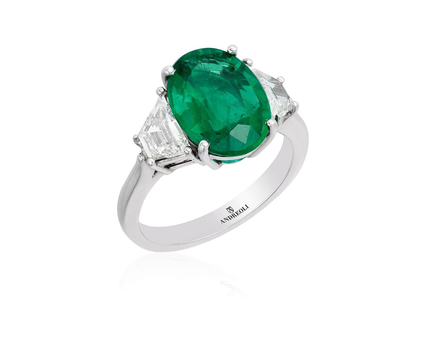 Andreoli CDC Certified 4.05 Carat Zambian Emerald Diamond Platinum Ring. This Ring features 1.02 carat F-G Color VS-SI Clarity Trapezoid step cut diamonds and a 4.05 carat oval Zambian CDC certified vivid green emerald with minor oil. Set in 8.87