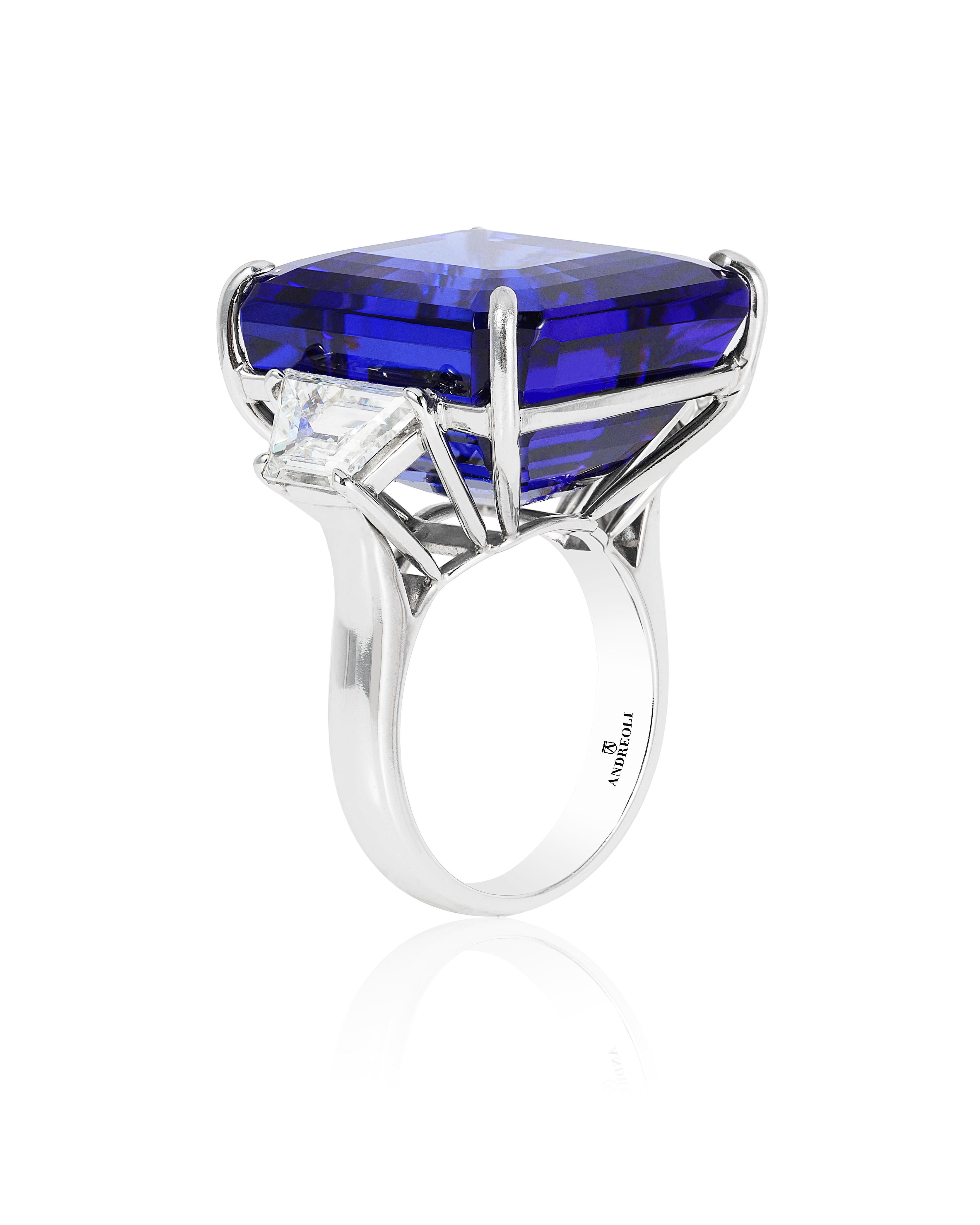 Andreoli CDC Certified 42.70 Carat Vivid Blue Tanzanite Diamond Platinum Ring. This ring features a 42.70 carat vivid blue tanzanite certified by C. Dunaigre Switzerland lab. Accented with two trapezoid step cut diamonds 1.87 carats. Set in