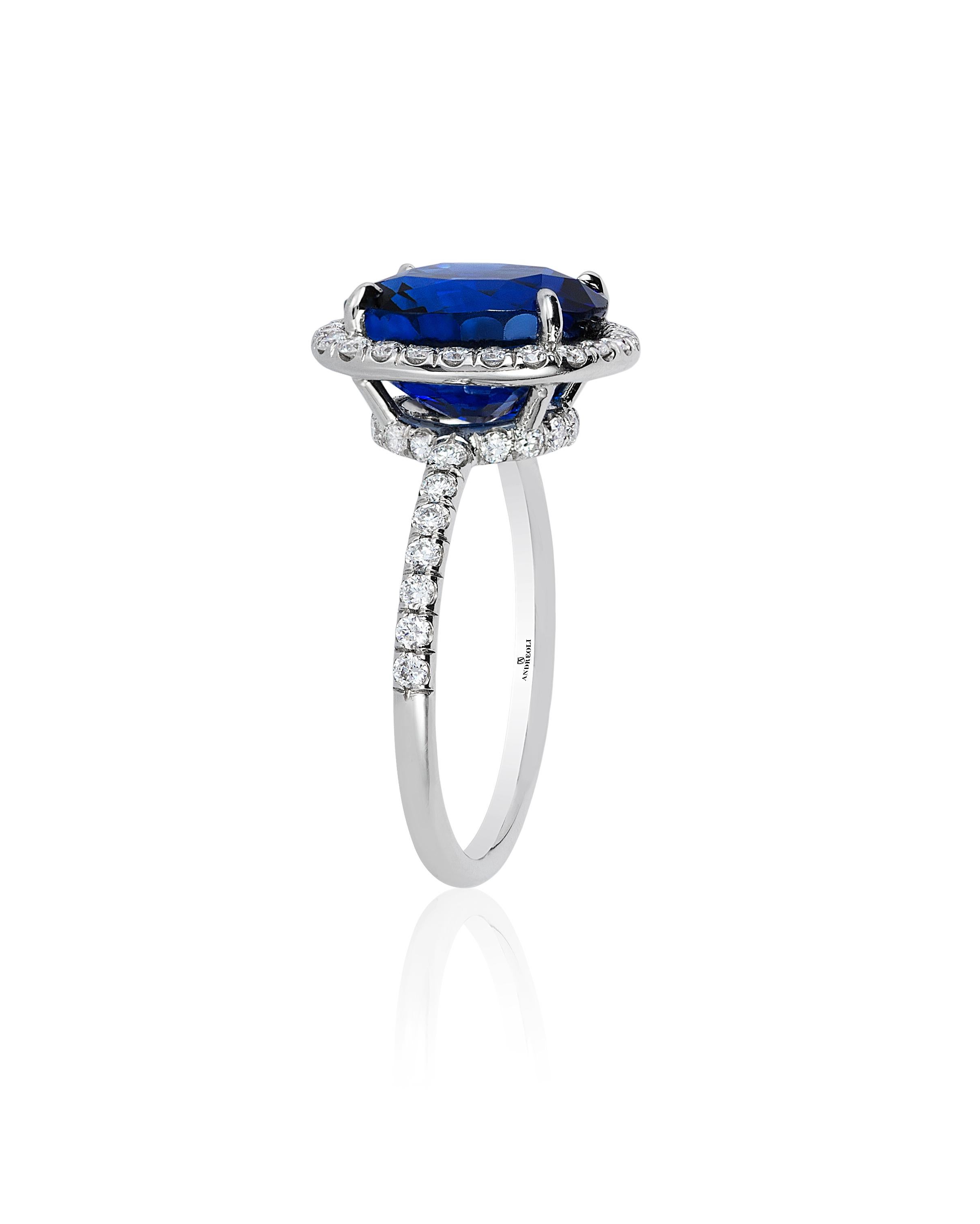 Andreoli CDC Certified 6.31 Carat Ceylon Blue Sapphire Diamond Platinum Ring. This ring features a 6.31 carat vivid blue cushion Ceylon blue sapphire certified by C. Dunaigre Consulting Switzerland surrounded with 0.56 carats of round brilliant