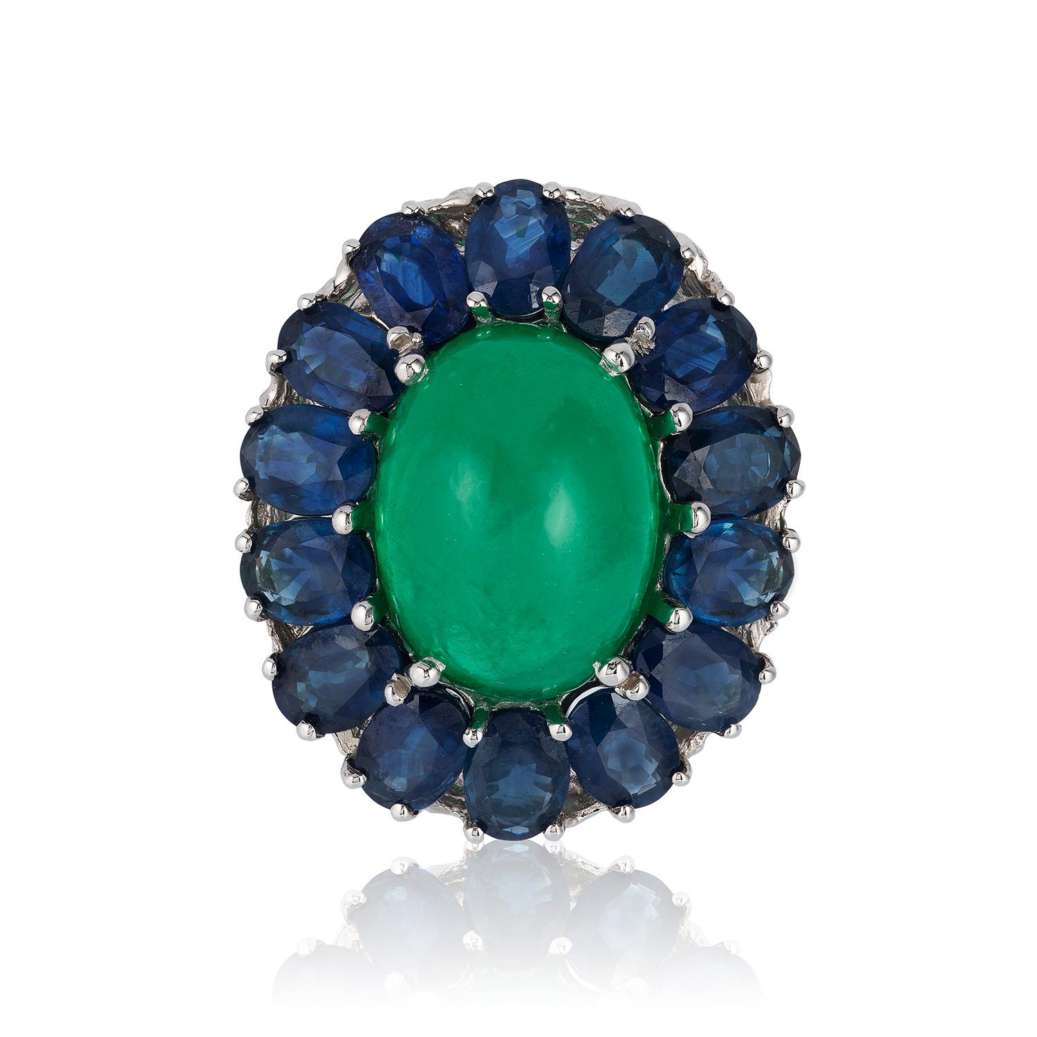 Andreoli Colombian Cabochon Emerald Blue Sapphire Cocktail Dome Ring

This Ring Features a 17.43 carat vivid green Colombian dome shaped cabochon emerald accented with 11.25 carats of 7x5mm Blue sapphires from the legendary Kanchanaburi mine in